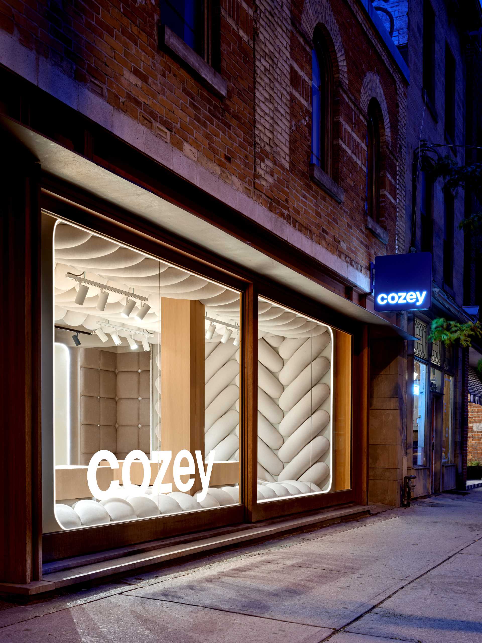 The design of this retail window showcase displays a giant fabric weave to draw pedestrians inside the space.