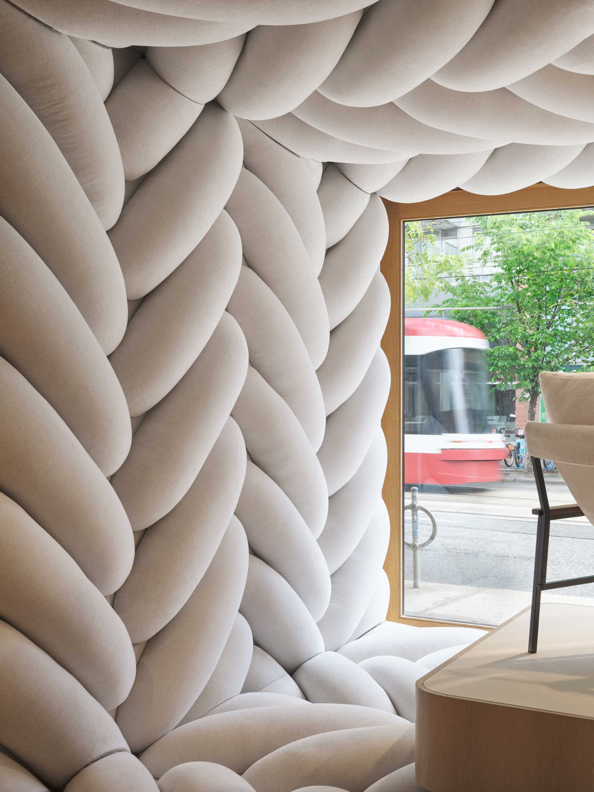 The design of this retail window showcase displays a giant fabric weave to draw pedestrians inside the space.