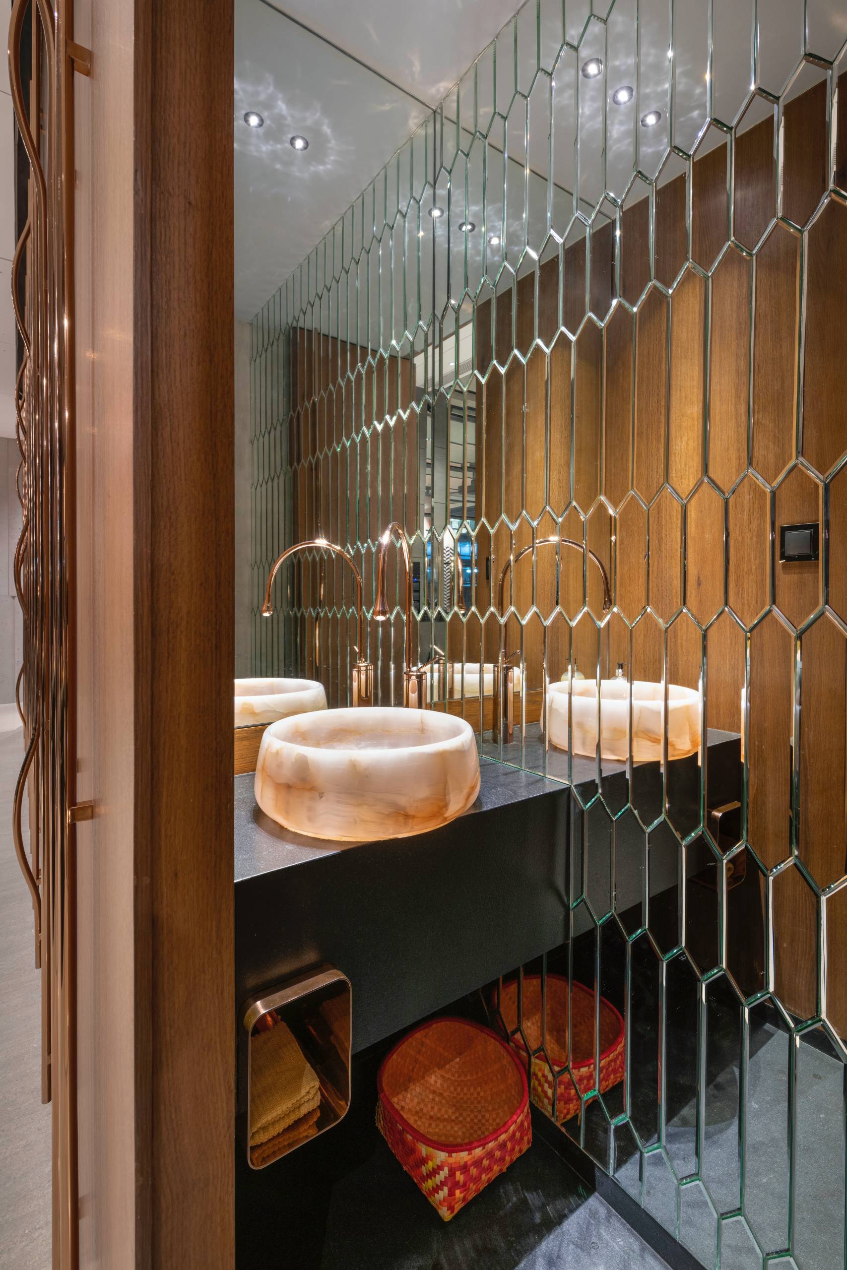 A modern bathroom with mirrored tiles.