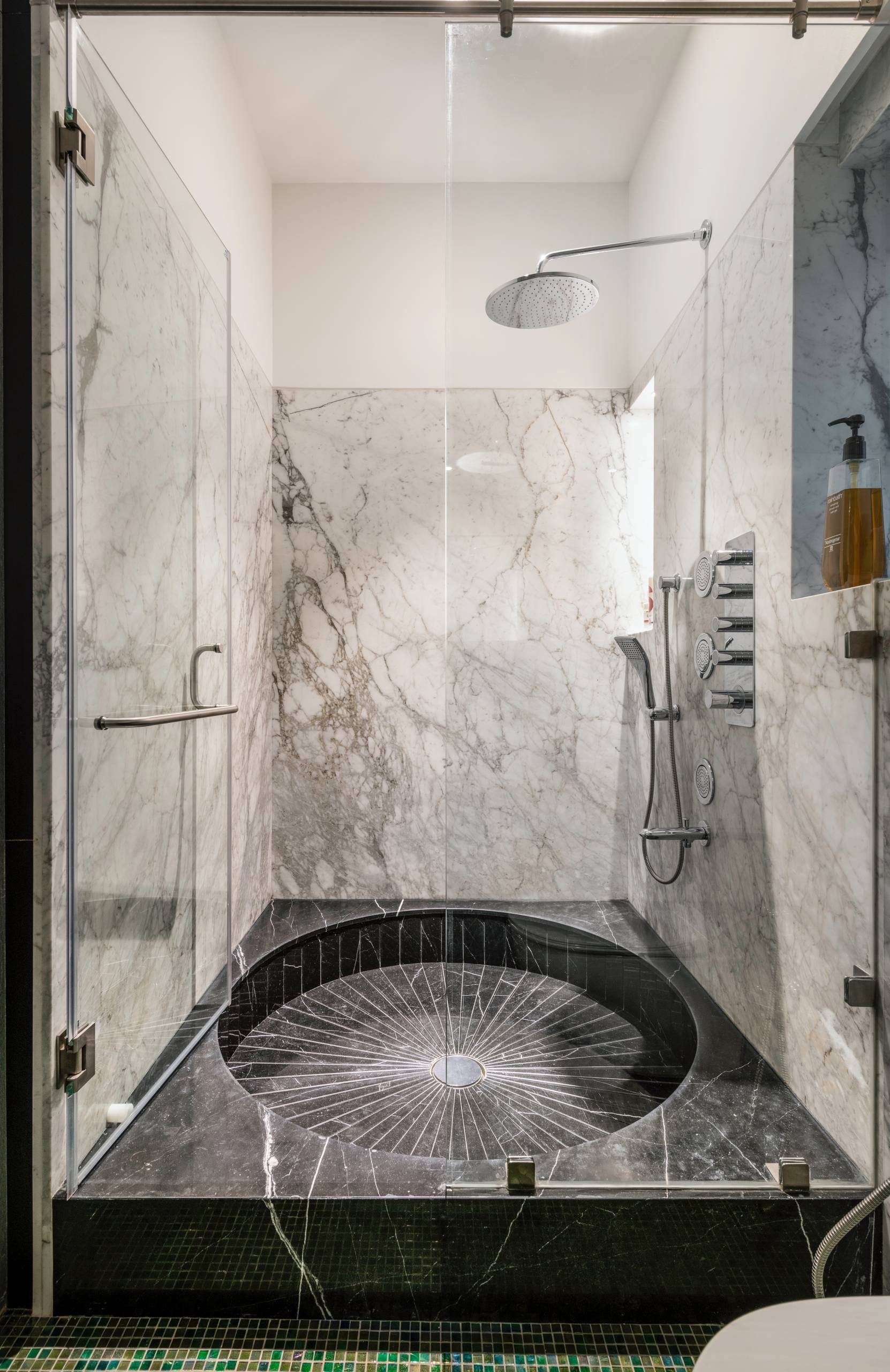 A modern shower with a sunken floor.