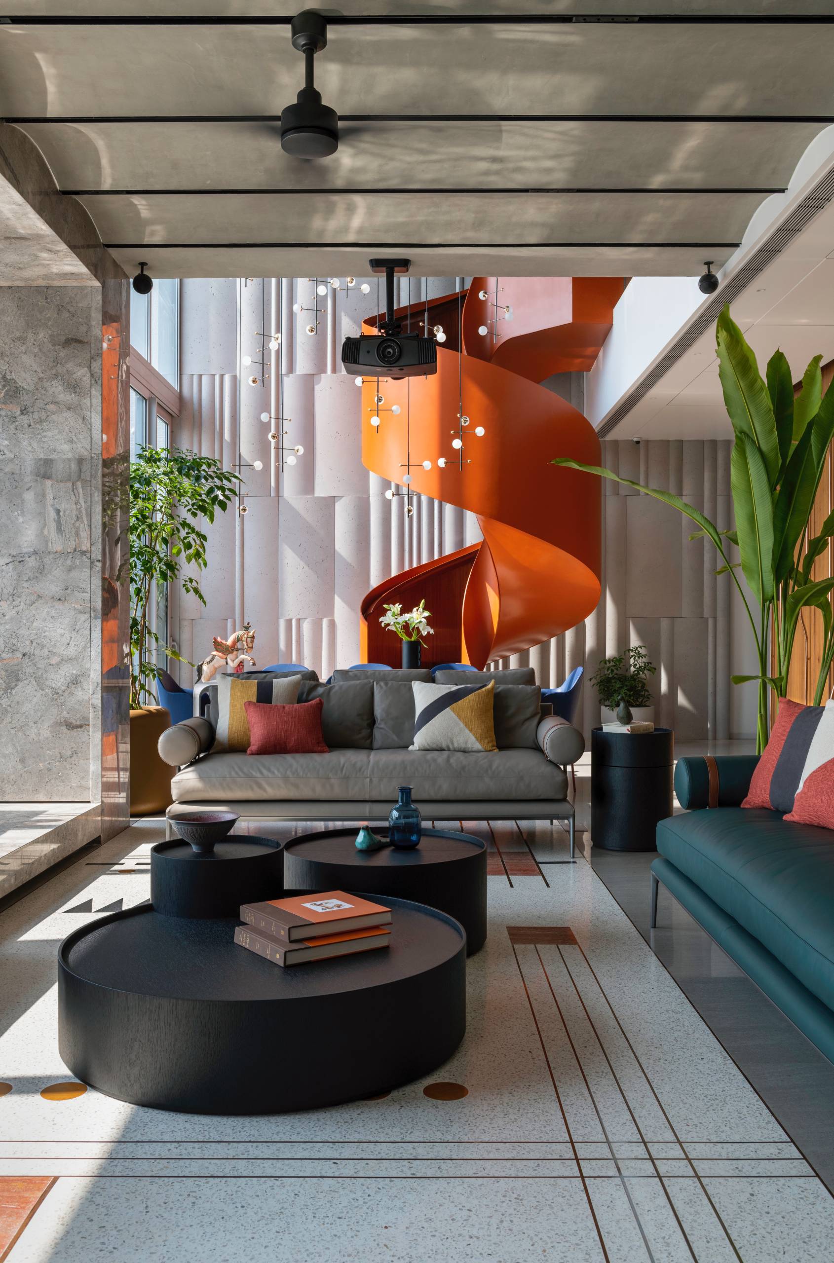 A modern penthouse with a bright orange spiral staircase.