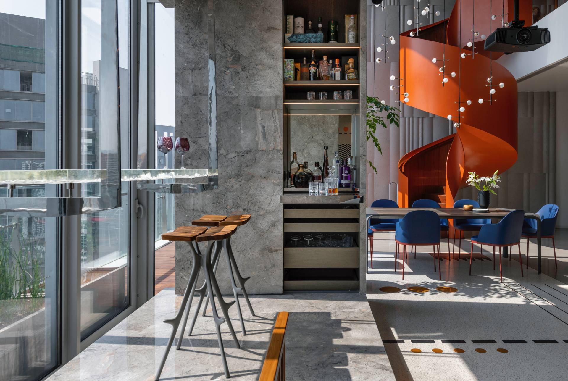 A modern penthouse with a bright orange spiral staircase.