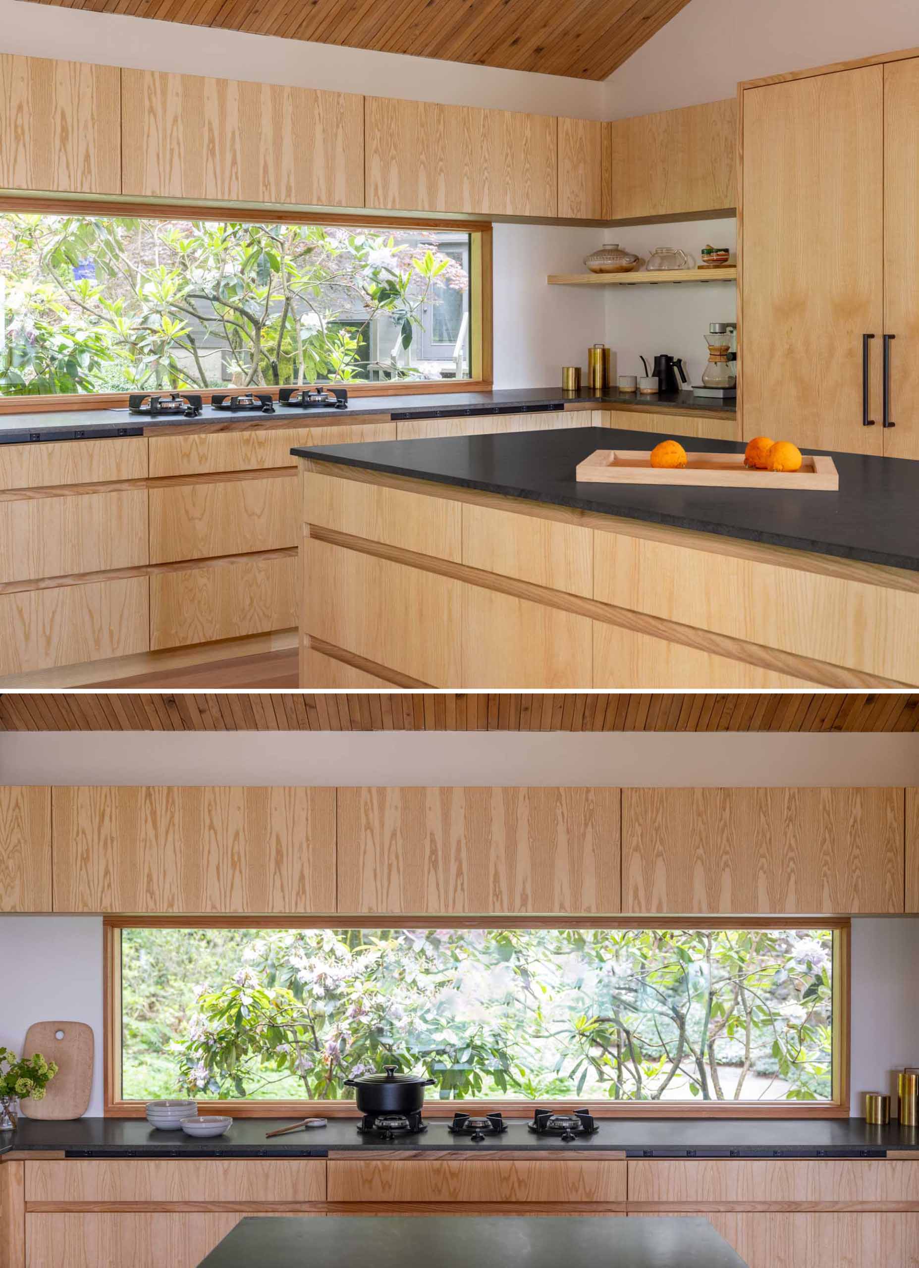 The kitchen includes a horizontal window above the cooktop, offering views of mature rhododendrons, as well as plain-sawn Ash cabinetry and Basaltina Natural Stone countertop with a honed finish.