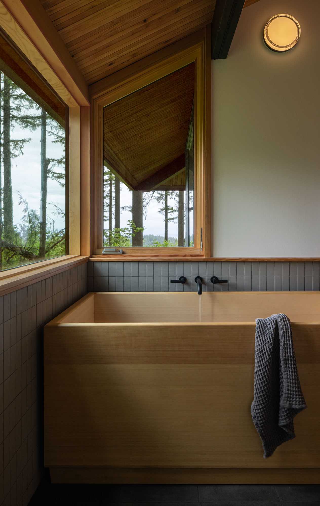 This bathroom includes a Japanese-inspired wood bathtub.