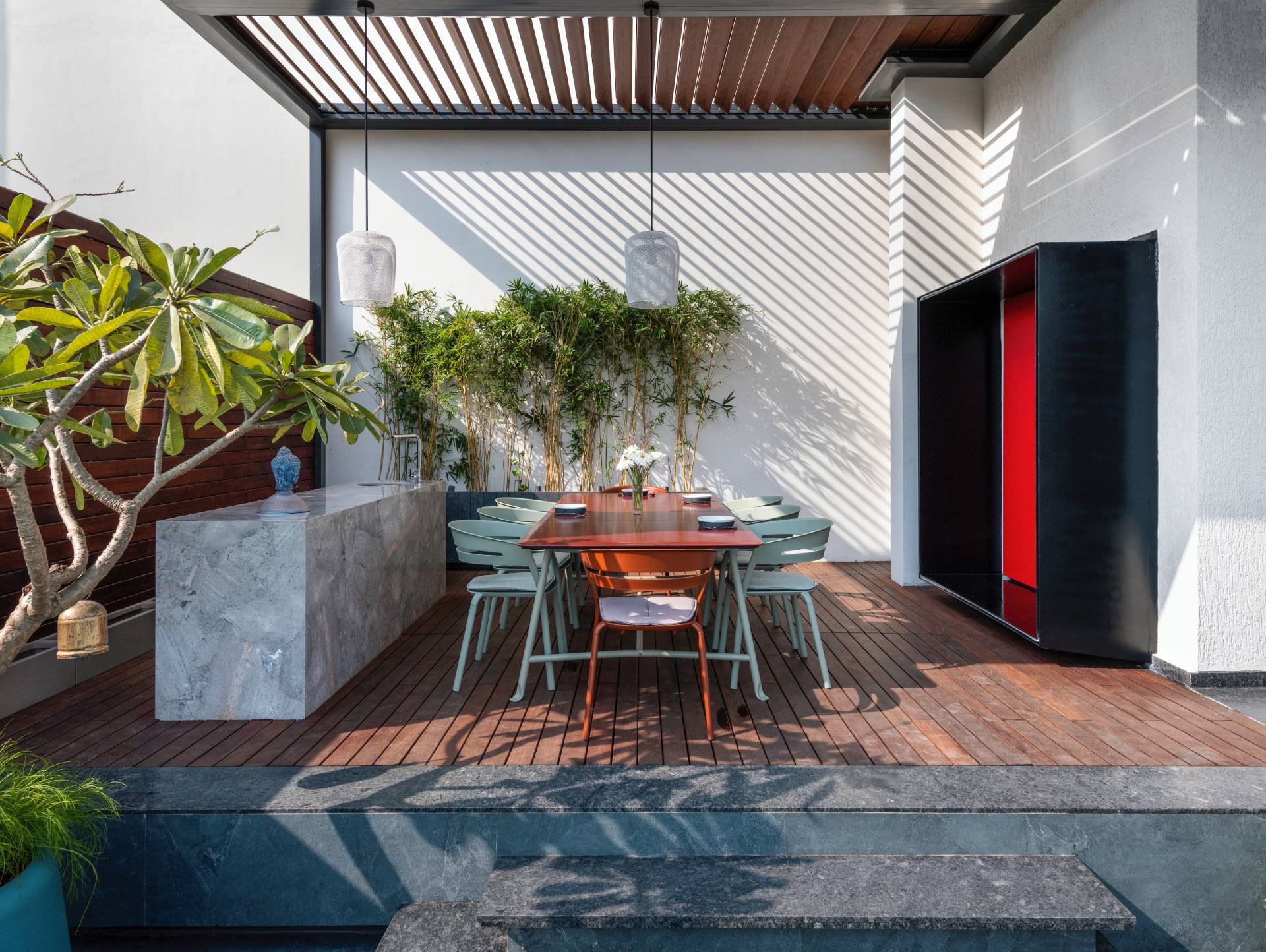 A modern penthouse with a terrace that has a dining area and multiple seating areas.