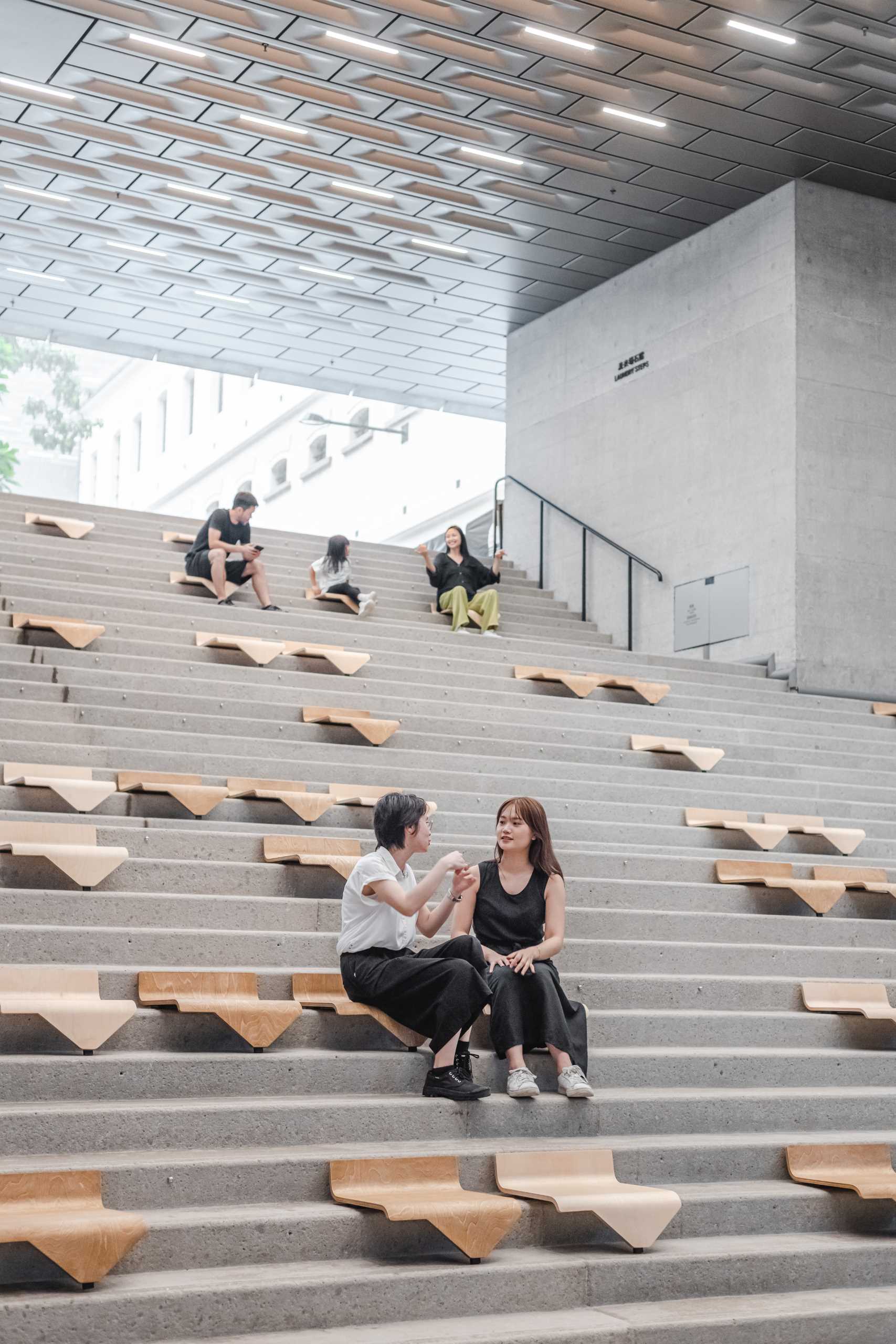 A collection of modular chairs for stairs that can be easily moved and stacked.