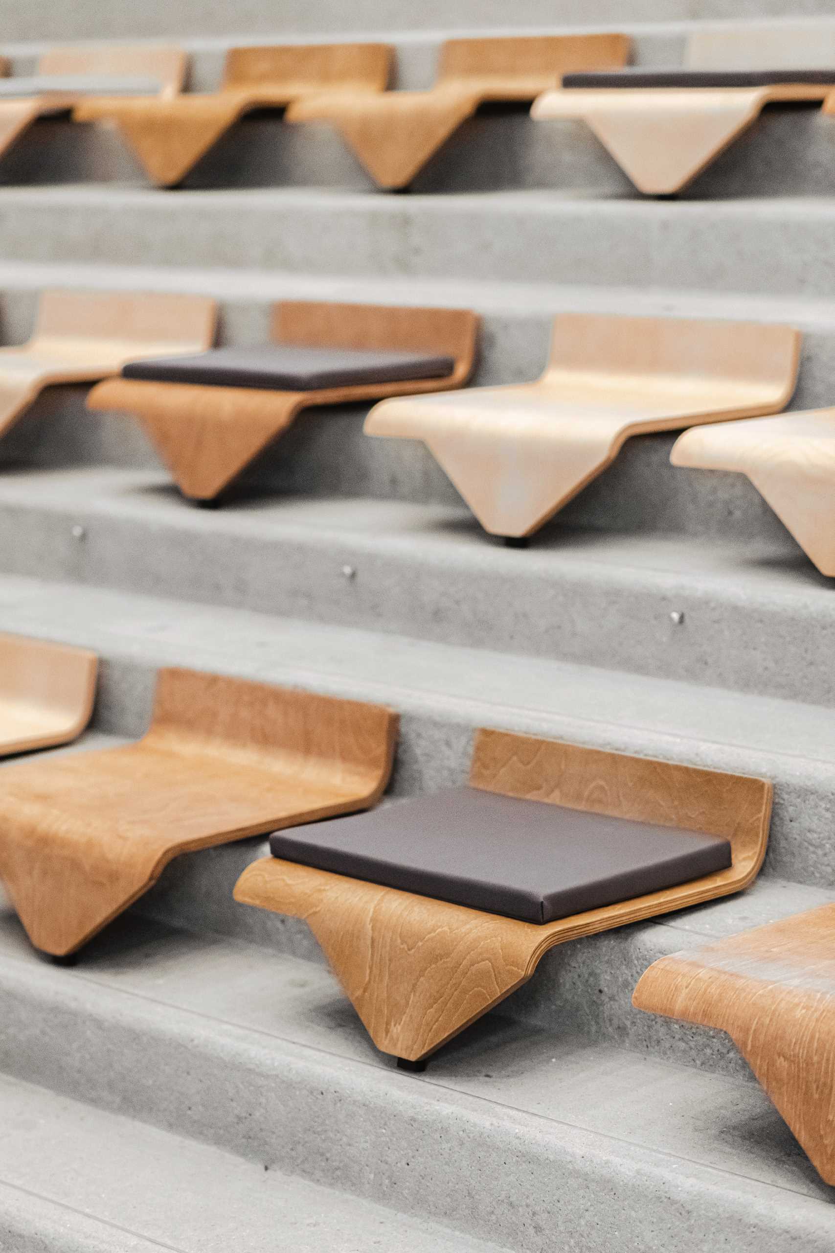 A collection of modular chairs for stairs that can be easily moved and stacked.