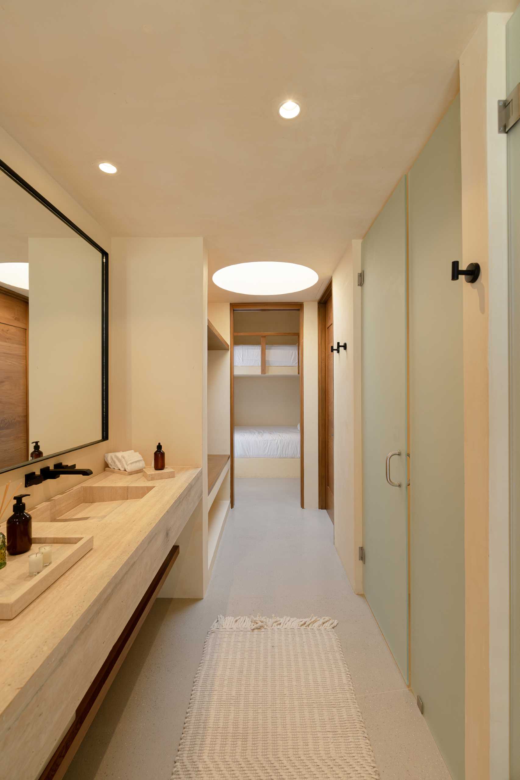 A contemporary bathroom featuring Travertine marble and a neutral palette.