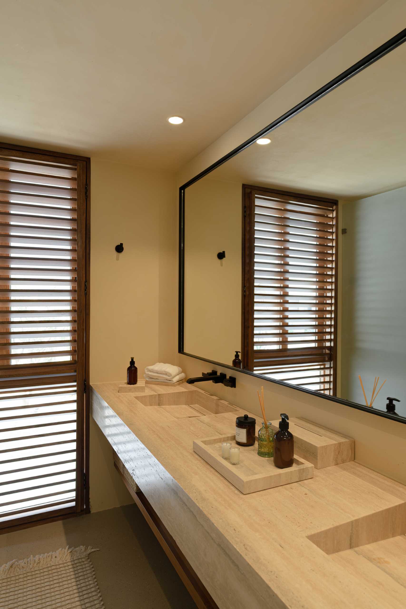 A contemporary bathroom featuring Travertine marble and a neutral palette.