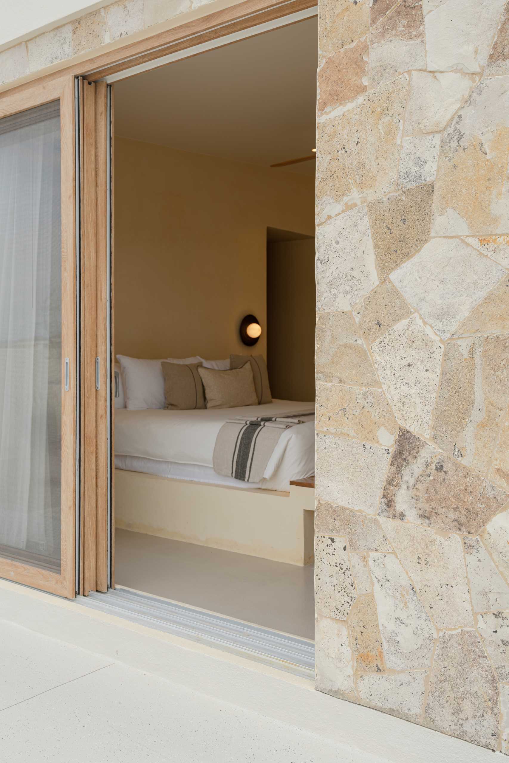 A contemporary beachside bedroom with a neutral palette.