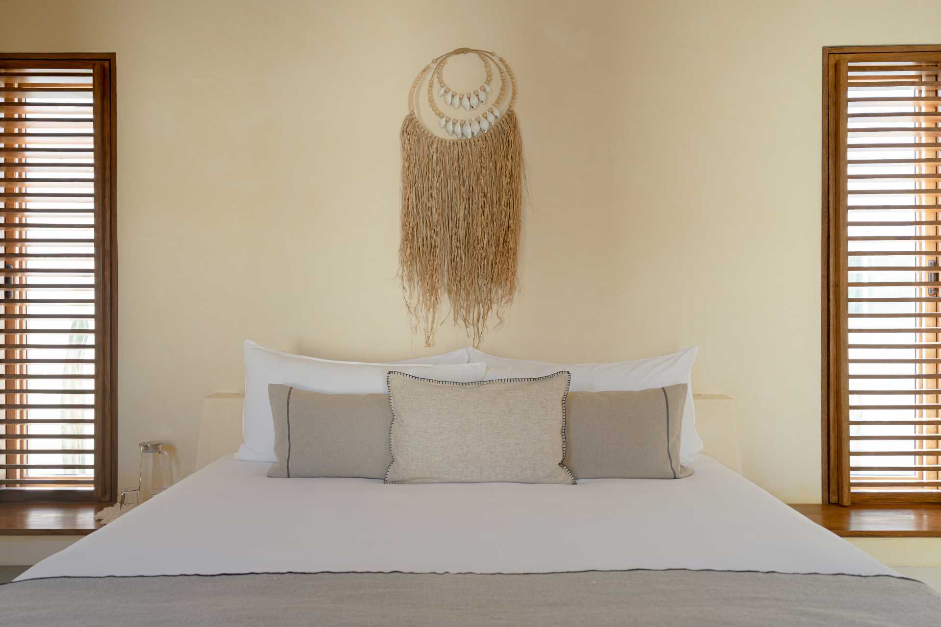 A contemporary beachside bedroom with a neutral palette.