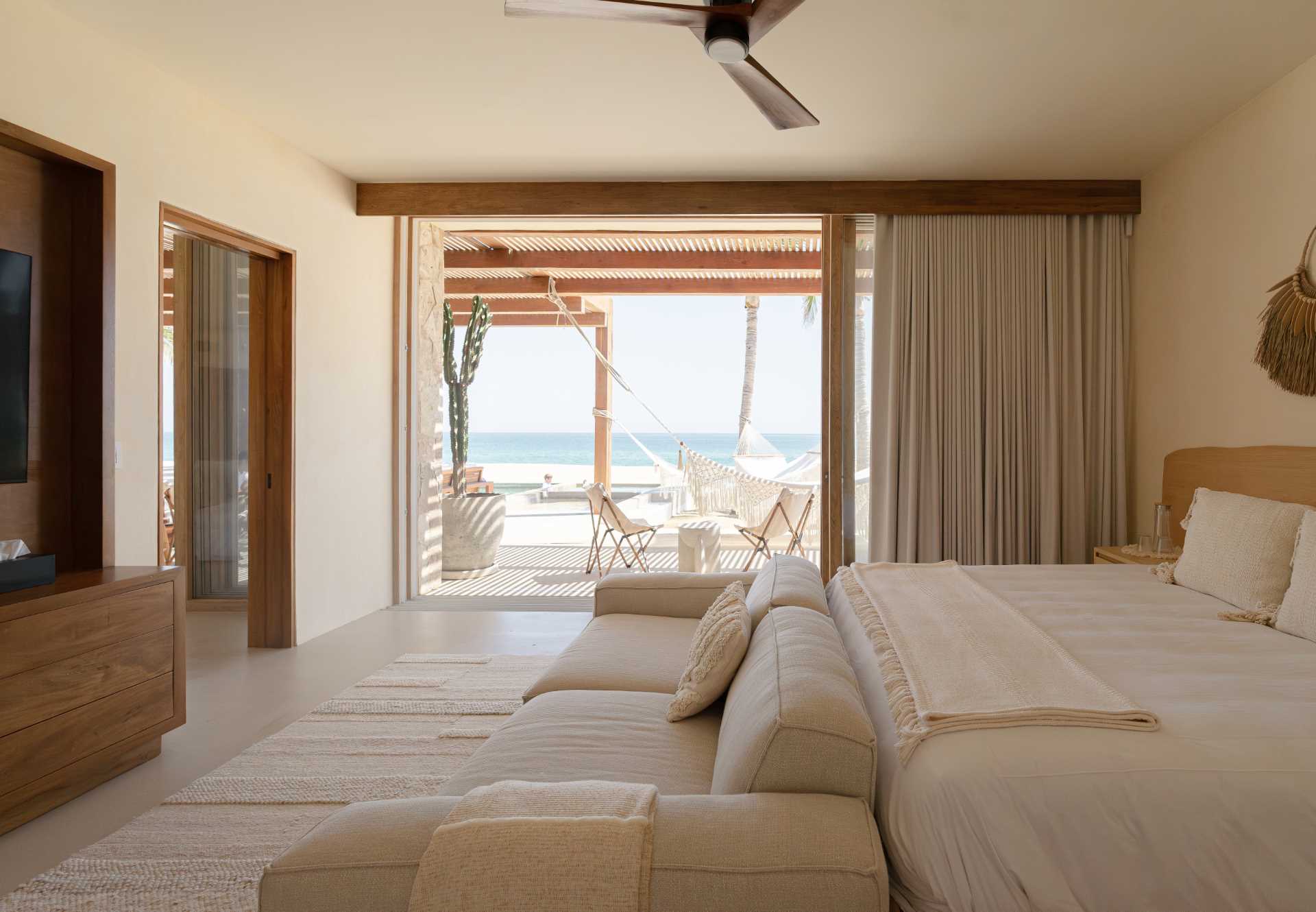 A contemporary beachside bedroom with a neutral palette.