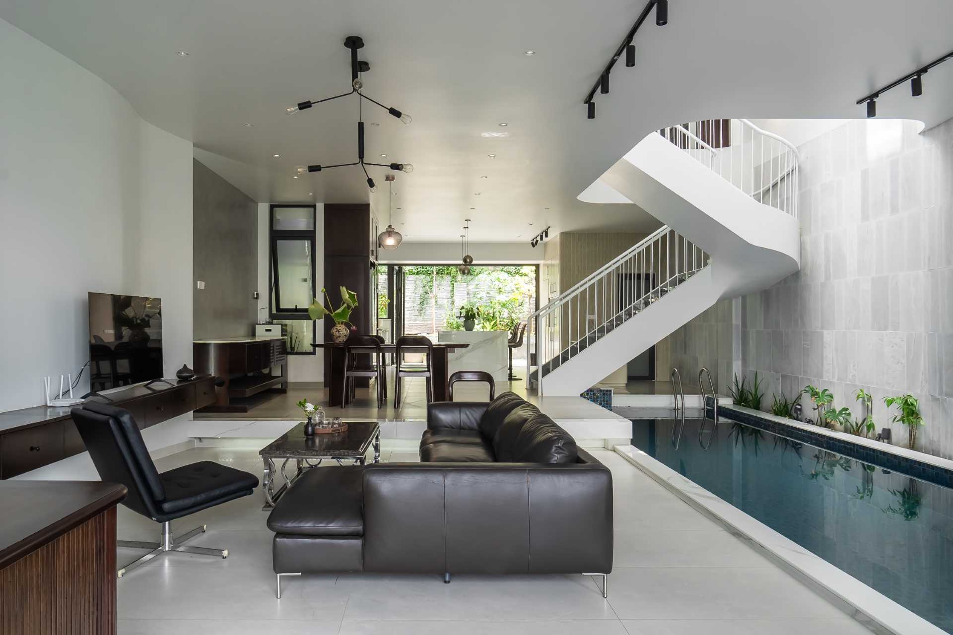 A modern villa in Vietnam has a man-made pool that connects seamlessly with the sky, where clouds drift above and are reflected in the water below.