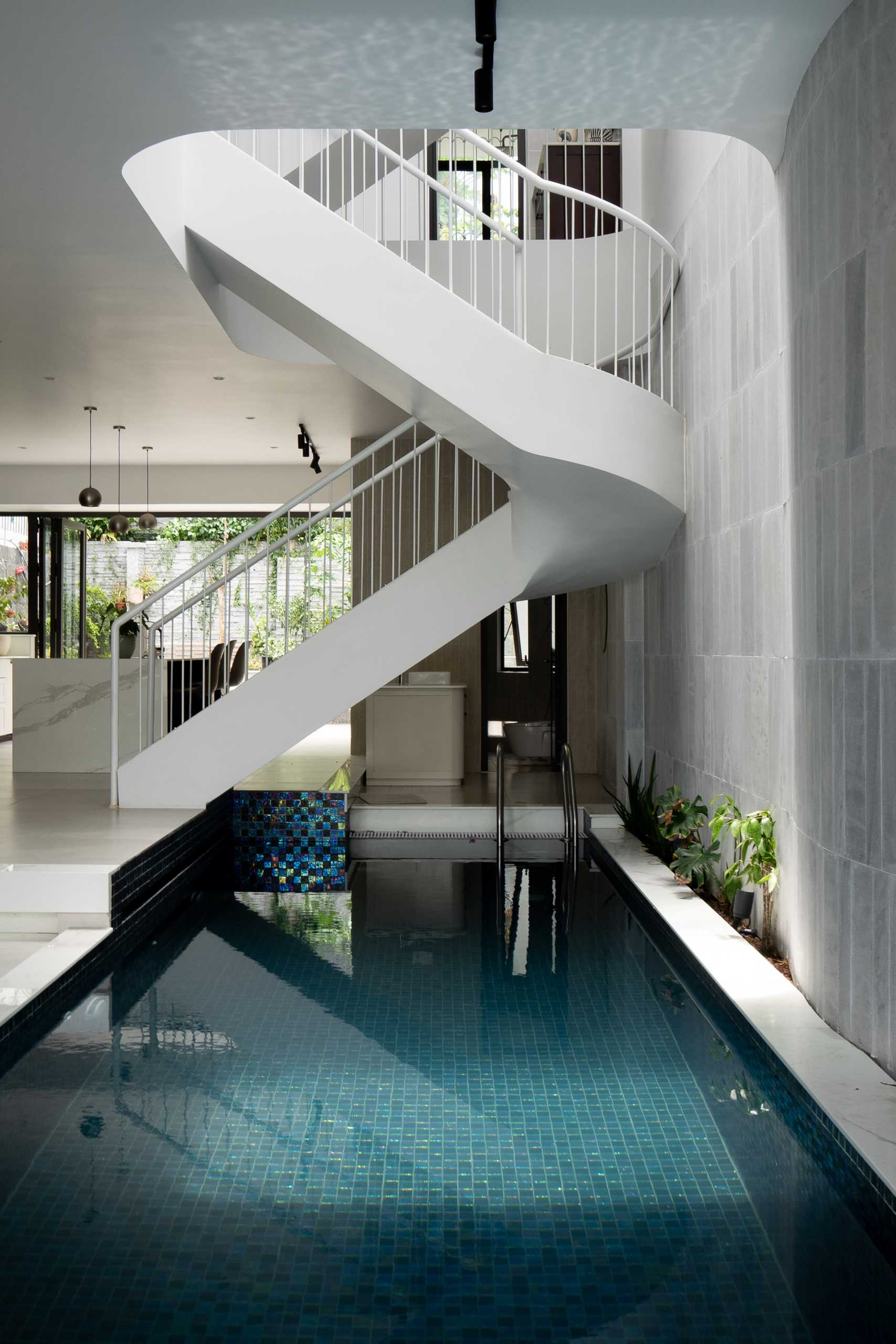 A modern villa in Vietnam has a man-made pool that connects seamlessly with the sky, where clouds drift above and are reflected in the water below.