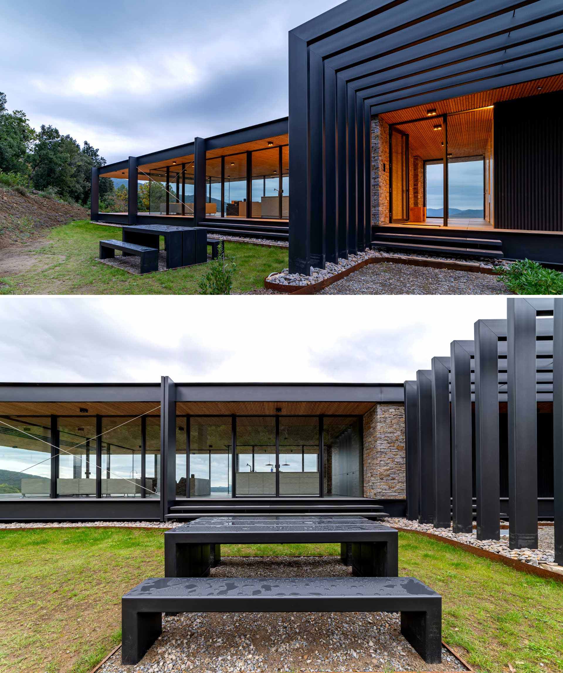 The steel structure of this modern home can be seen at the entryway, while the wood ceiling travels from the exterior to the interior, bringing a warmth to the home.