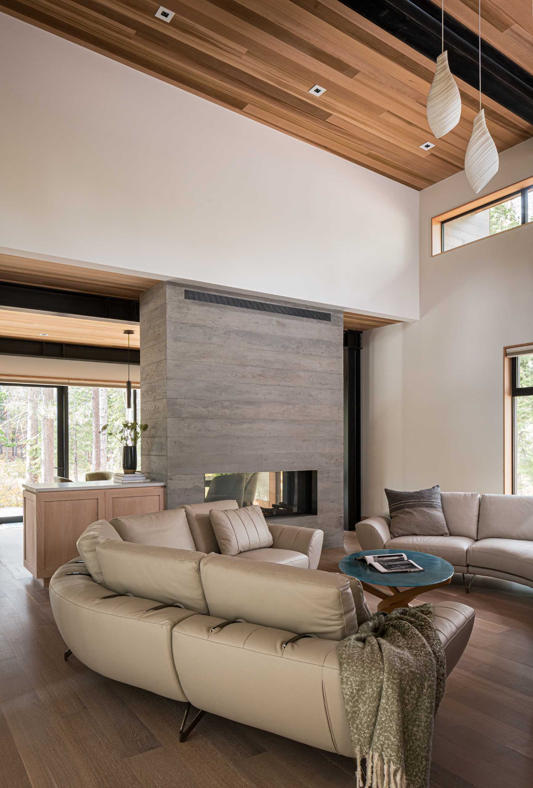 Inside this modern home, there's high ceilings and a double-sided fireplace that can be enjoyed from both the living room and the dining room.