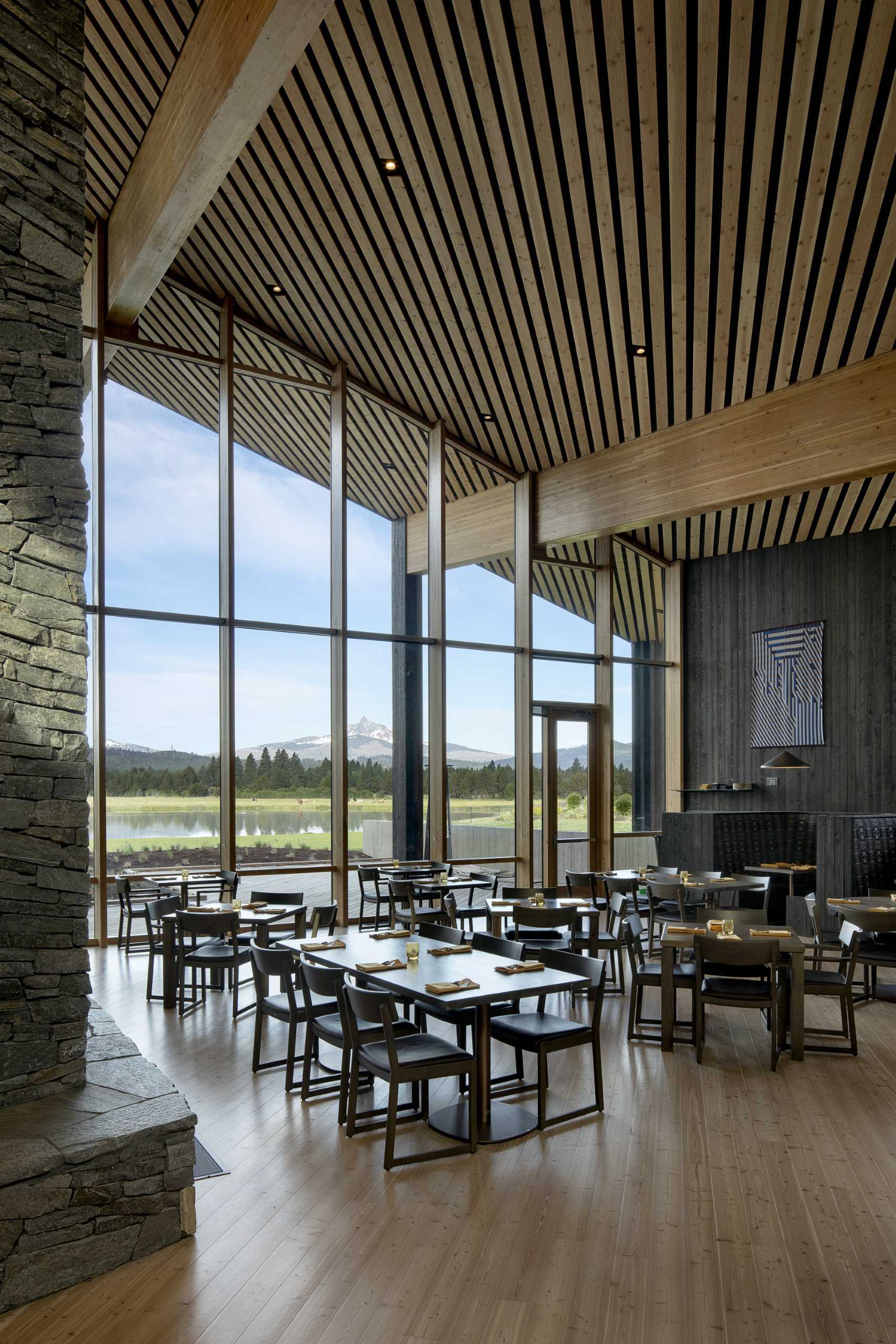 A modern ranch lodge with a black charred cedar exterior (shou sugi ban) and a warm wood interior.