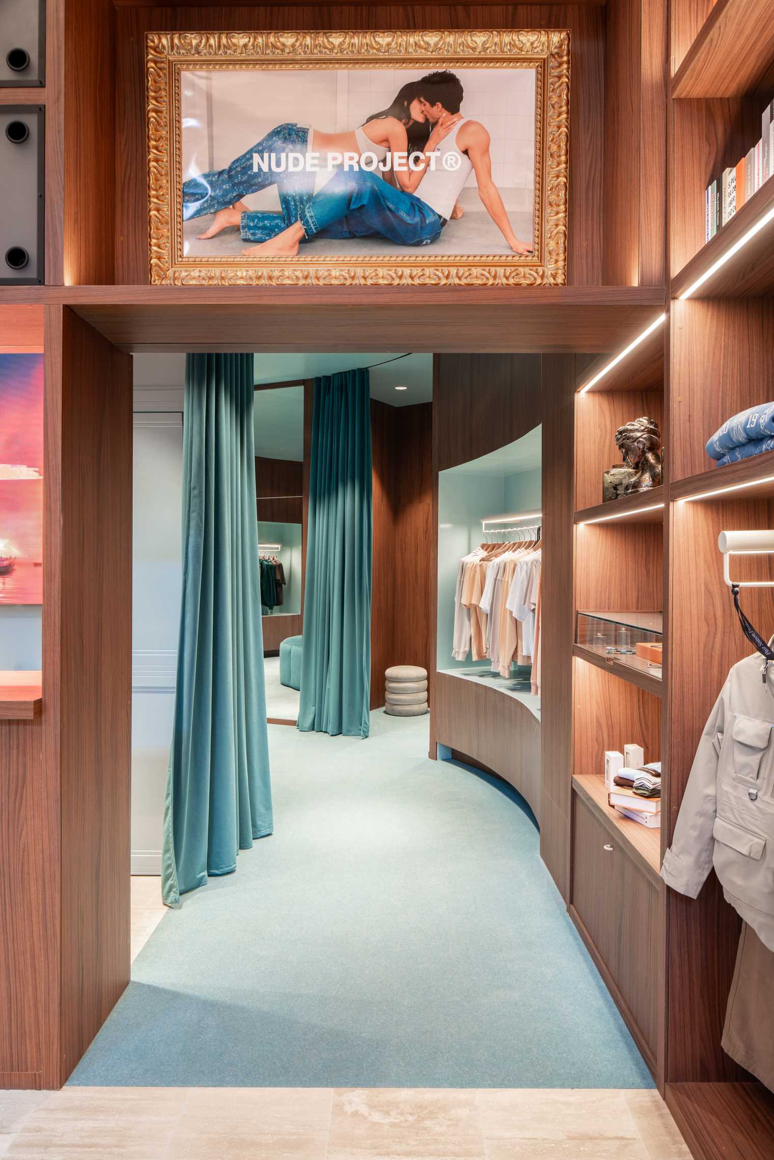 A modern streetwear retail store with 19-foot-high wooden bookshelves, a DJ booth, and a fitting room with baby blue accents.