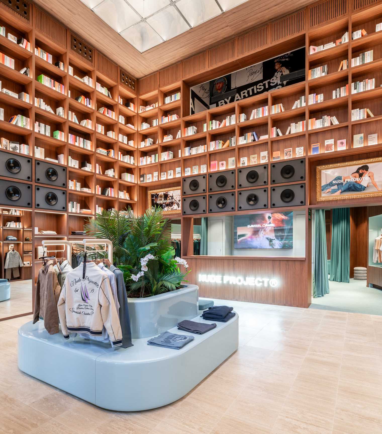 A modern streetwear retail store with 19-foot-high wooden bookshelves, a DJ booth, and a fitting room with baby blue accents.