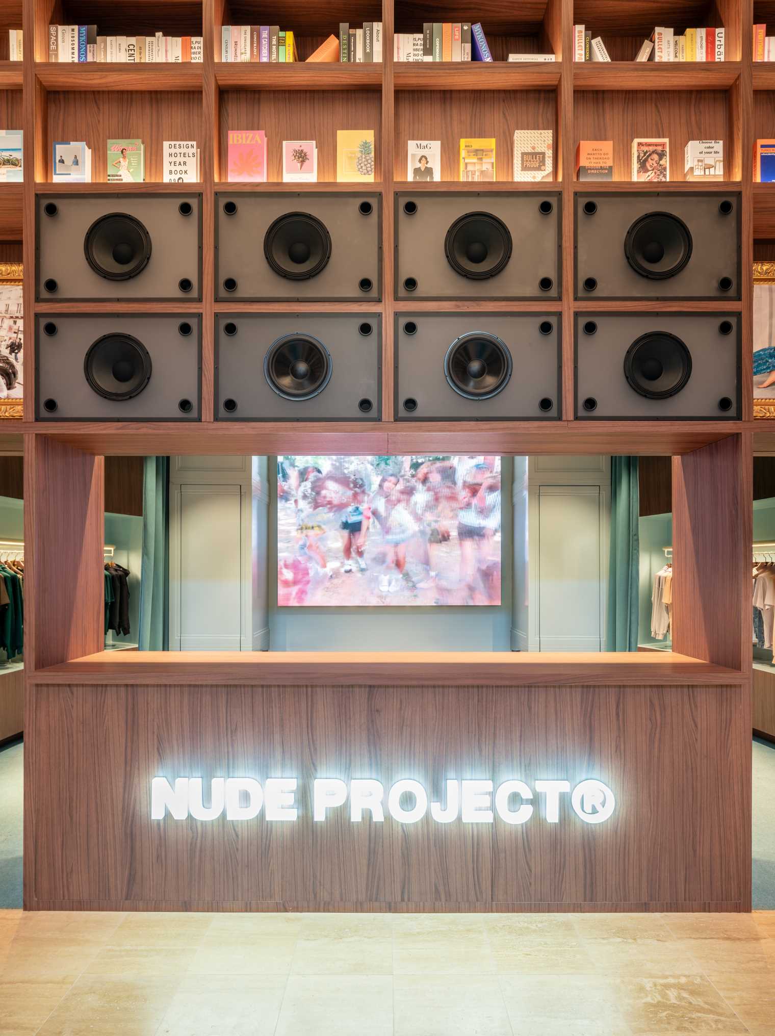 A modern streetwear retail store with 19-foot-high wooden bookshelves, a DJ booth, and a fitting room with baby blue accents.