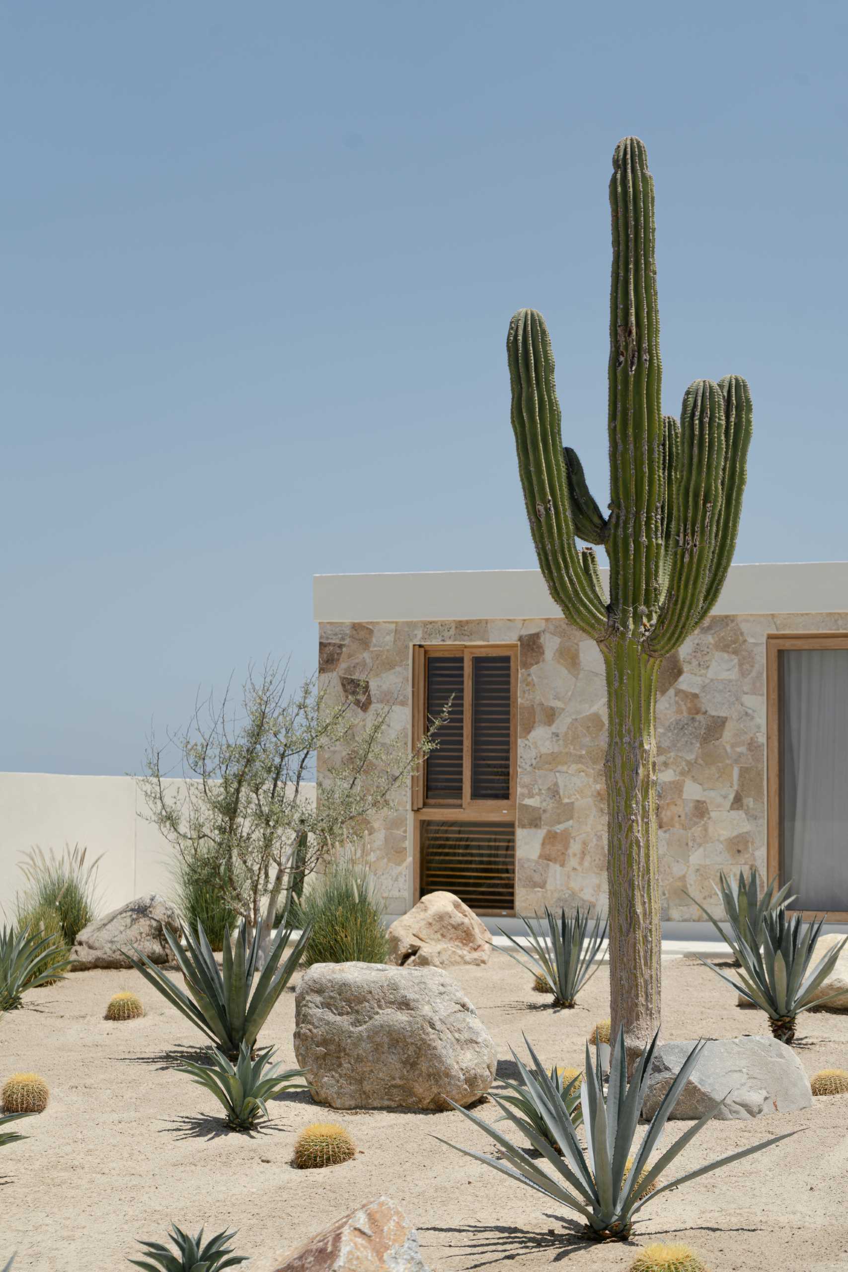 A contemporary stone house located on the beach.