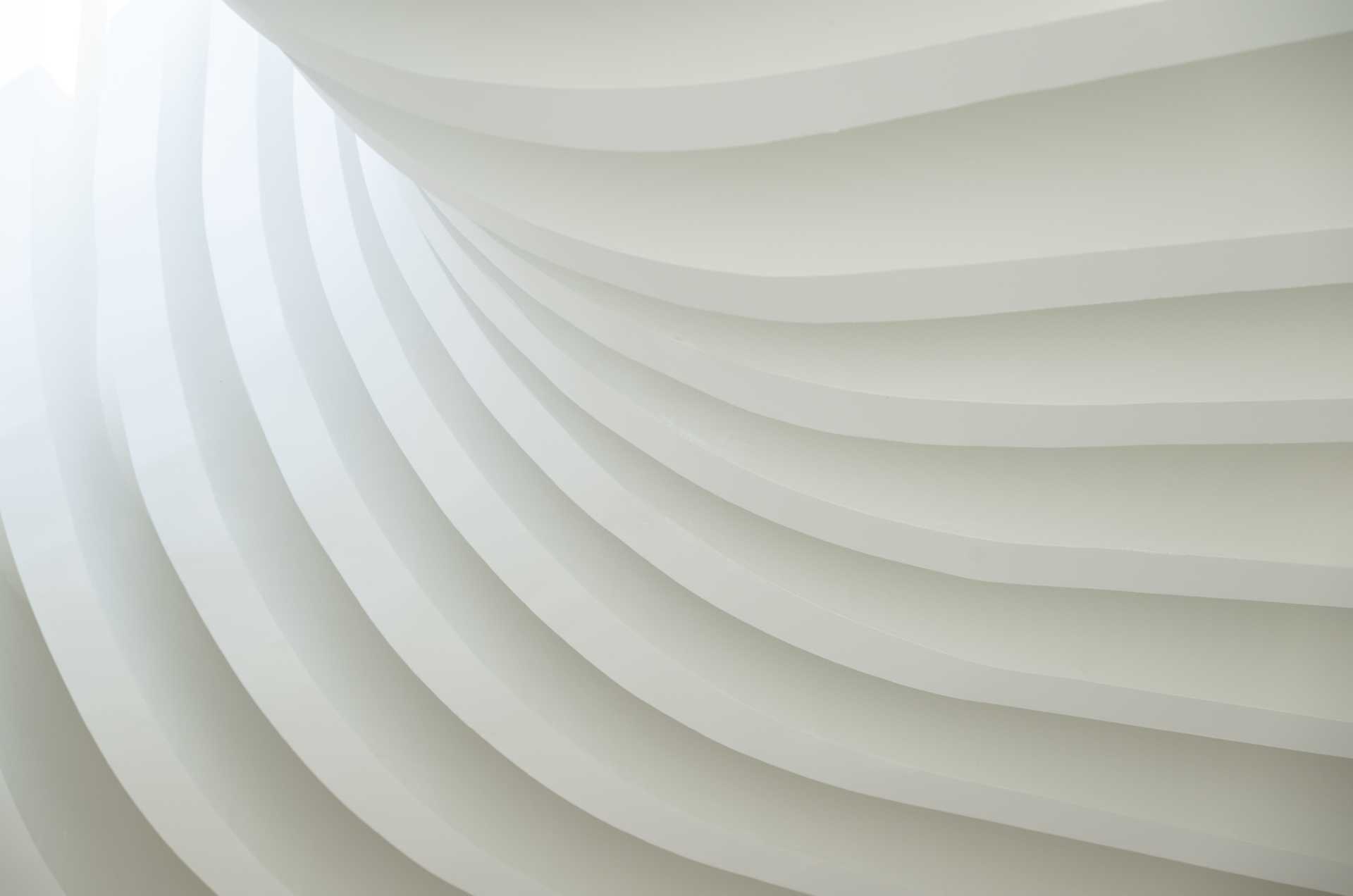 The structure of this modern cafe is on display with the vertical lines gathering at a central point where a skylight provides a glimpse of the sky.