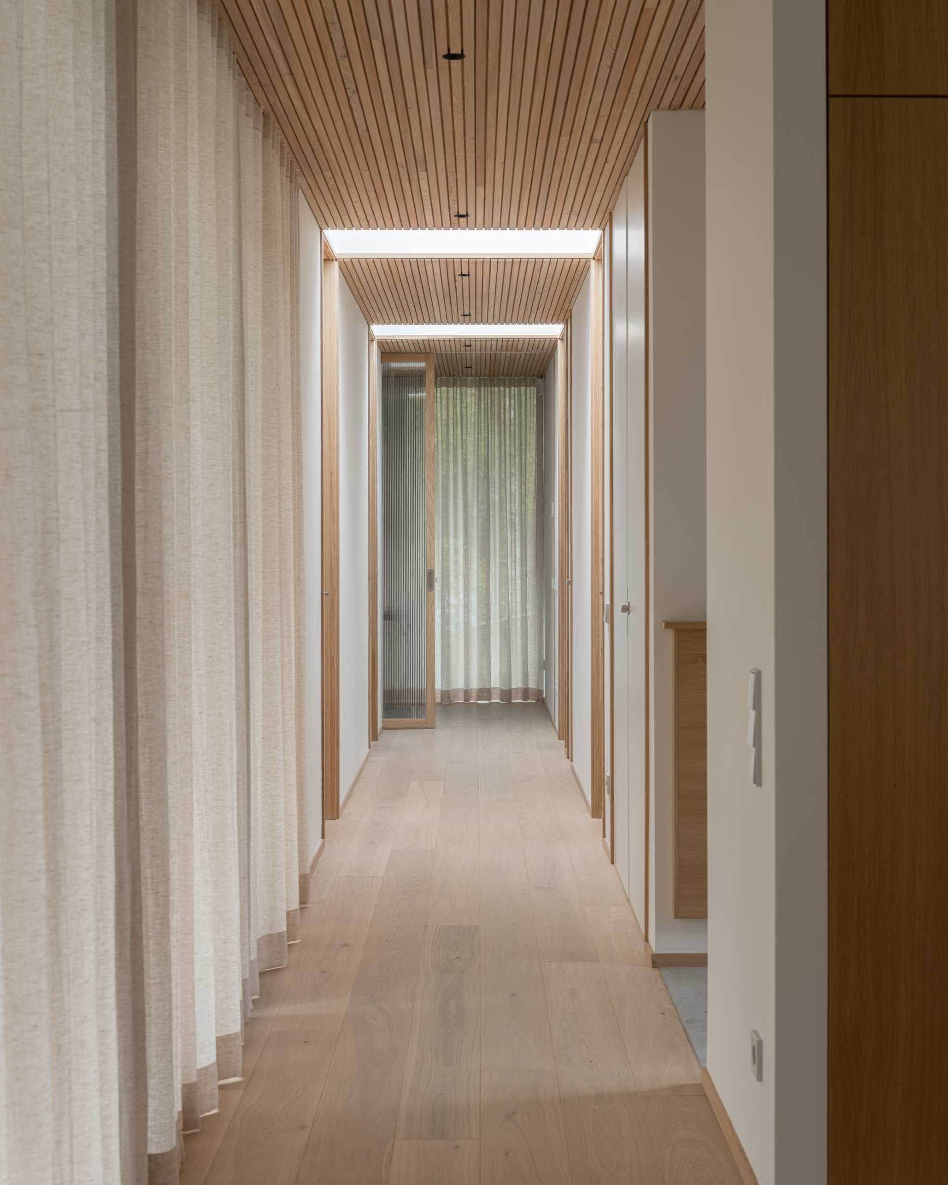 A hallway leads from the social areas of the home to the more private areas, like the bedrooms and bathrooms.