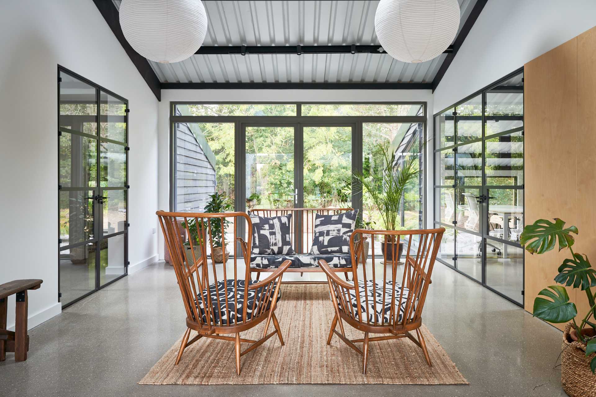 A unique design element of this home is the evening living room, that's located between the social spaces and a workroom. Crittall doors complement the other black accents throughout the home.