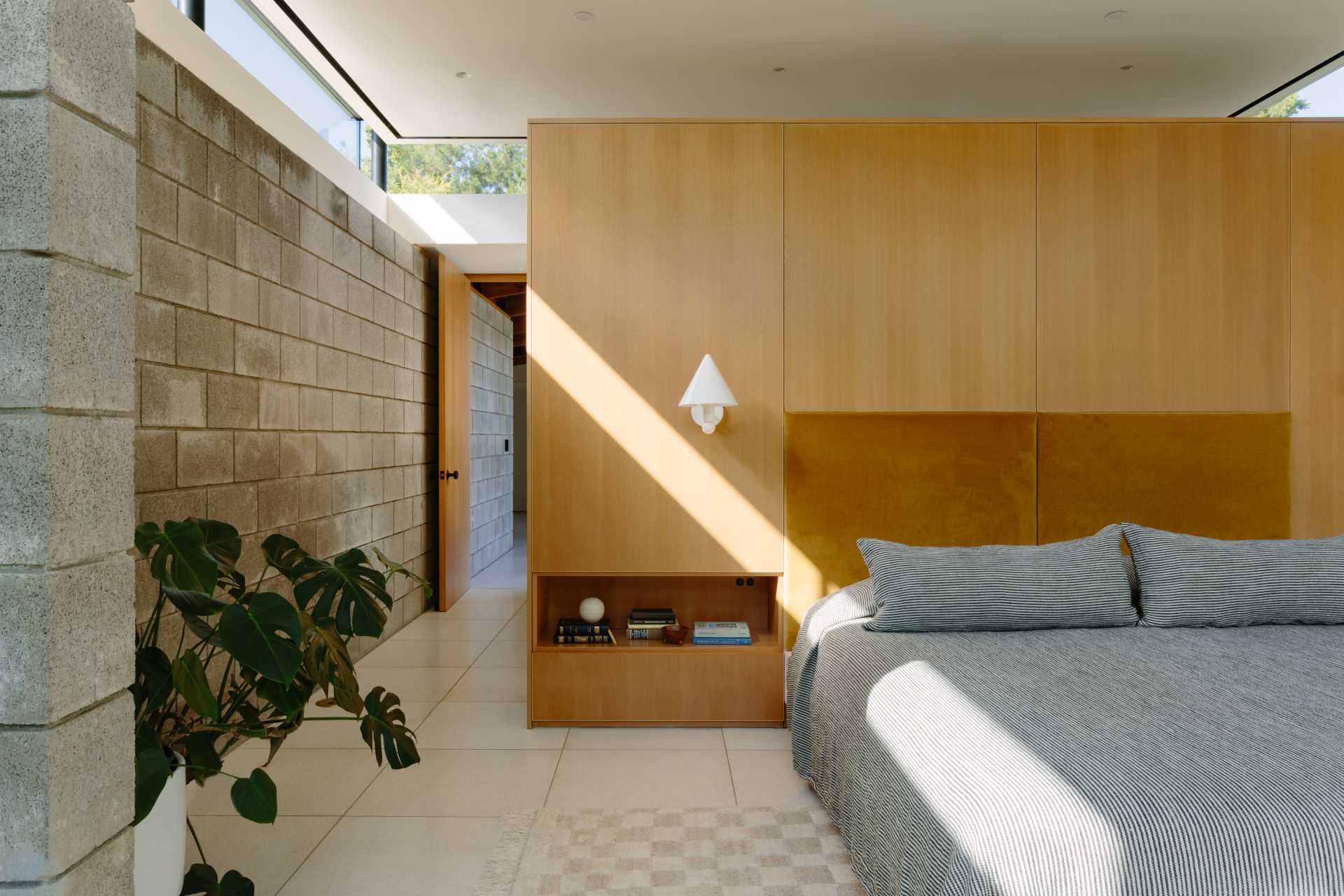 In this new primary bedroom, the clerestory windows allow the light to stream into the space.