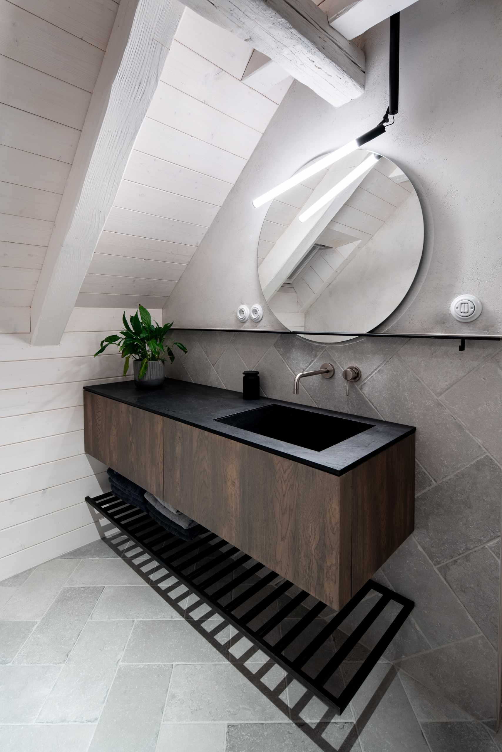 A modern grey, wood, and white bathroom.