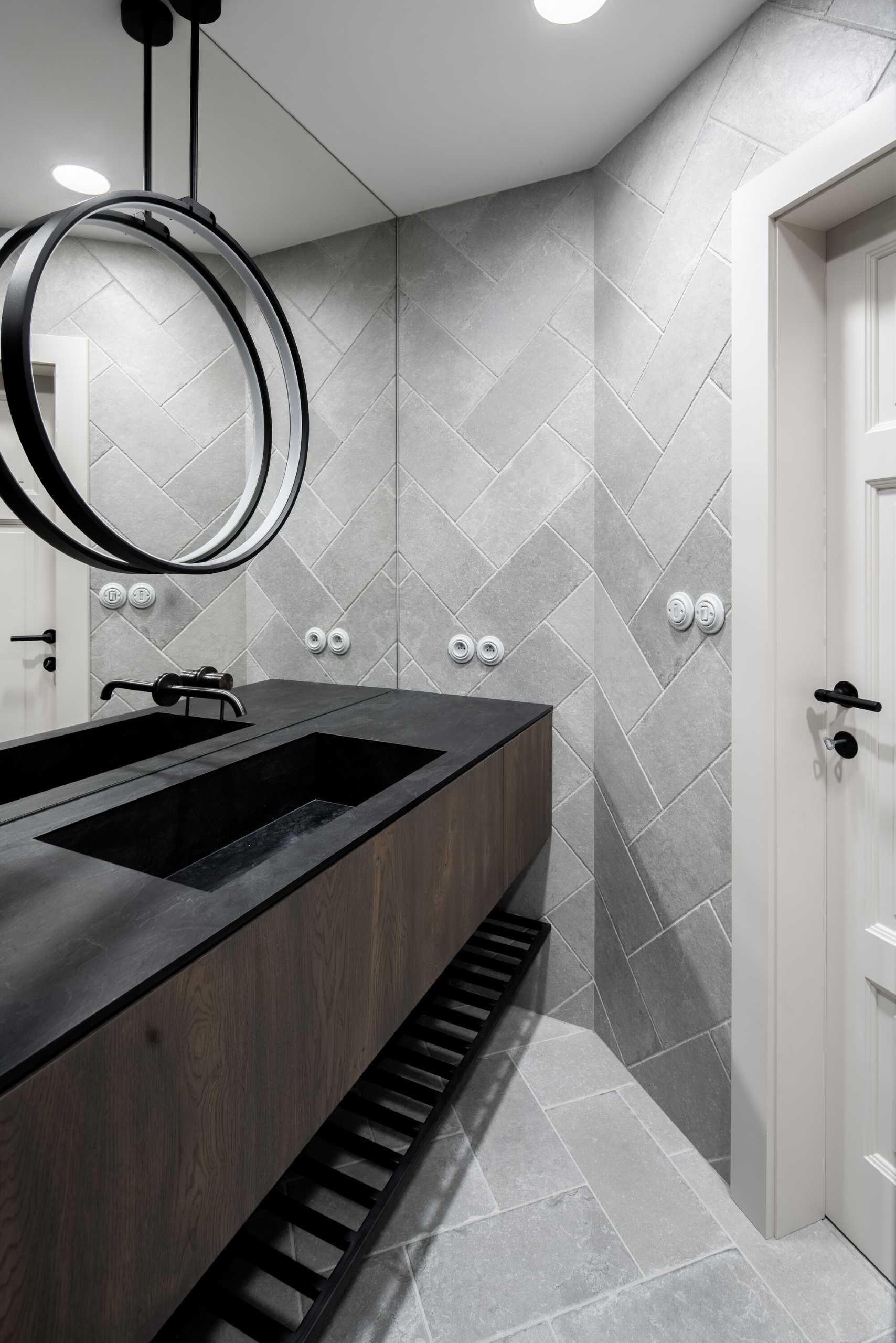 A modern grey, wood, and white bathroom.