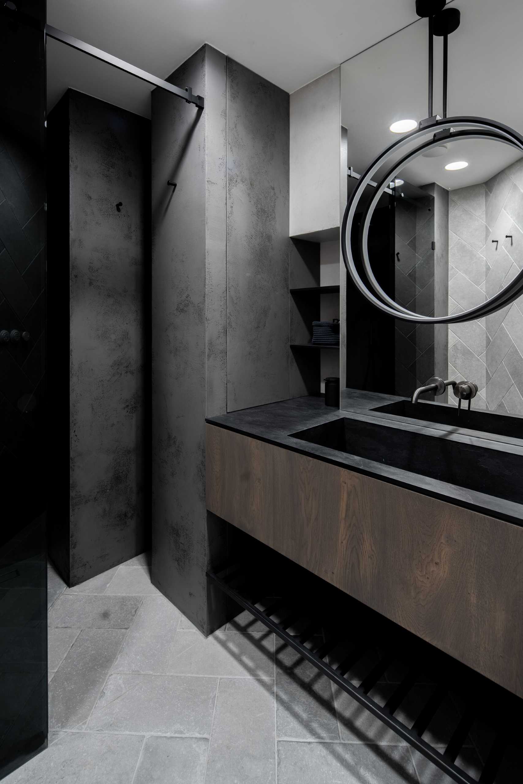 A modern grey, wood, and white bathroom.