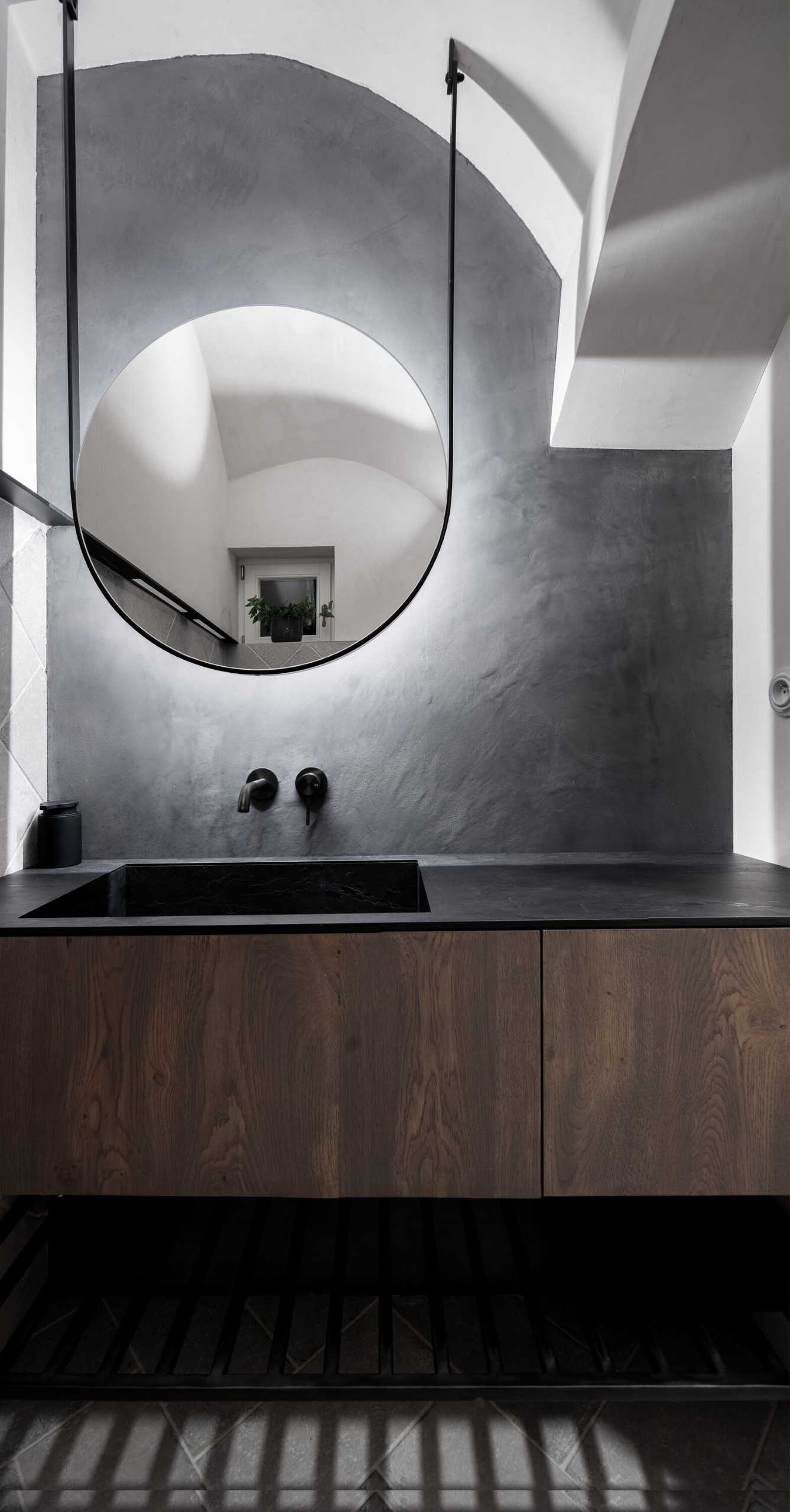 A modern grey, wood, and white bathroom.