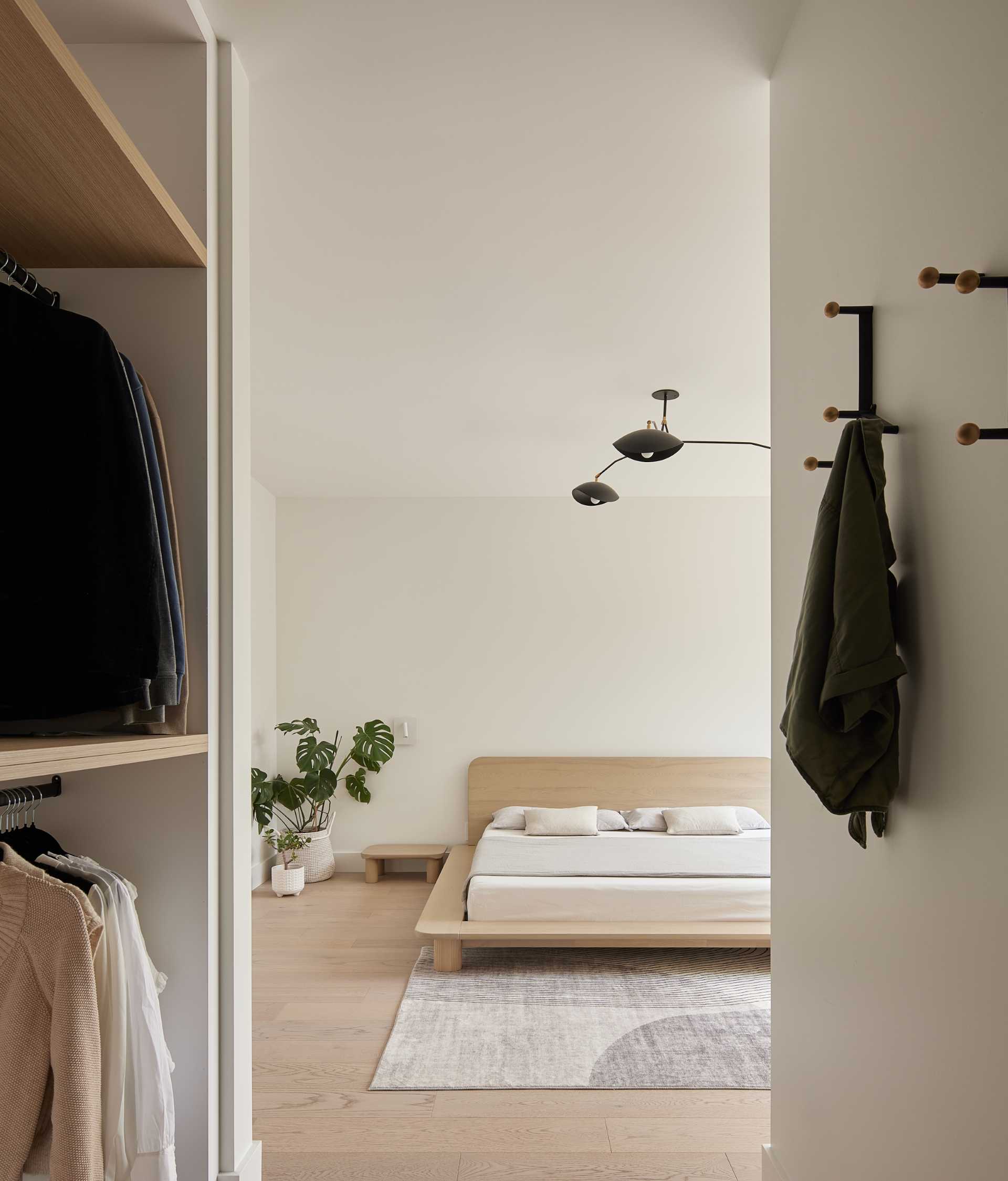 In this primary bedroom, furnishings have been kept minimal and include custom closets and a window bench.