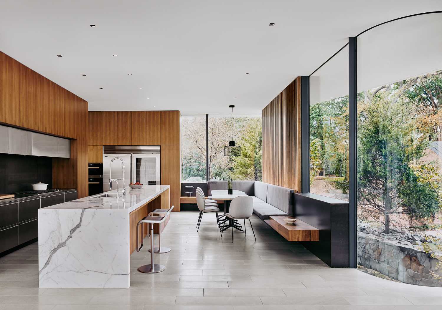 A modern kitchen and breakfast room, with built-in banquette seating.