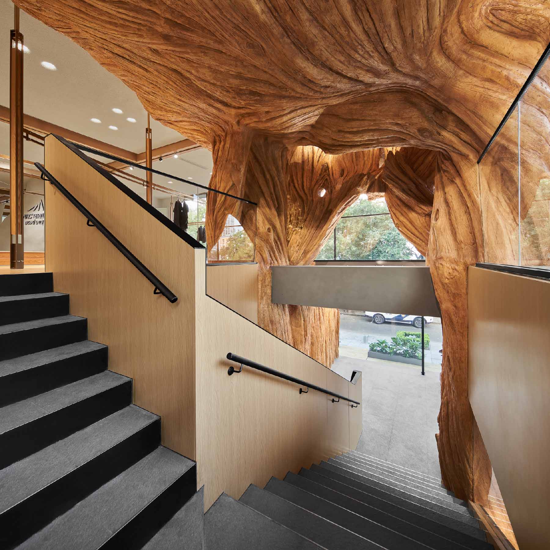 Modern retail store with a tree-like sculpture.