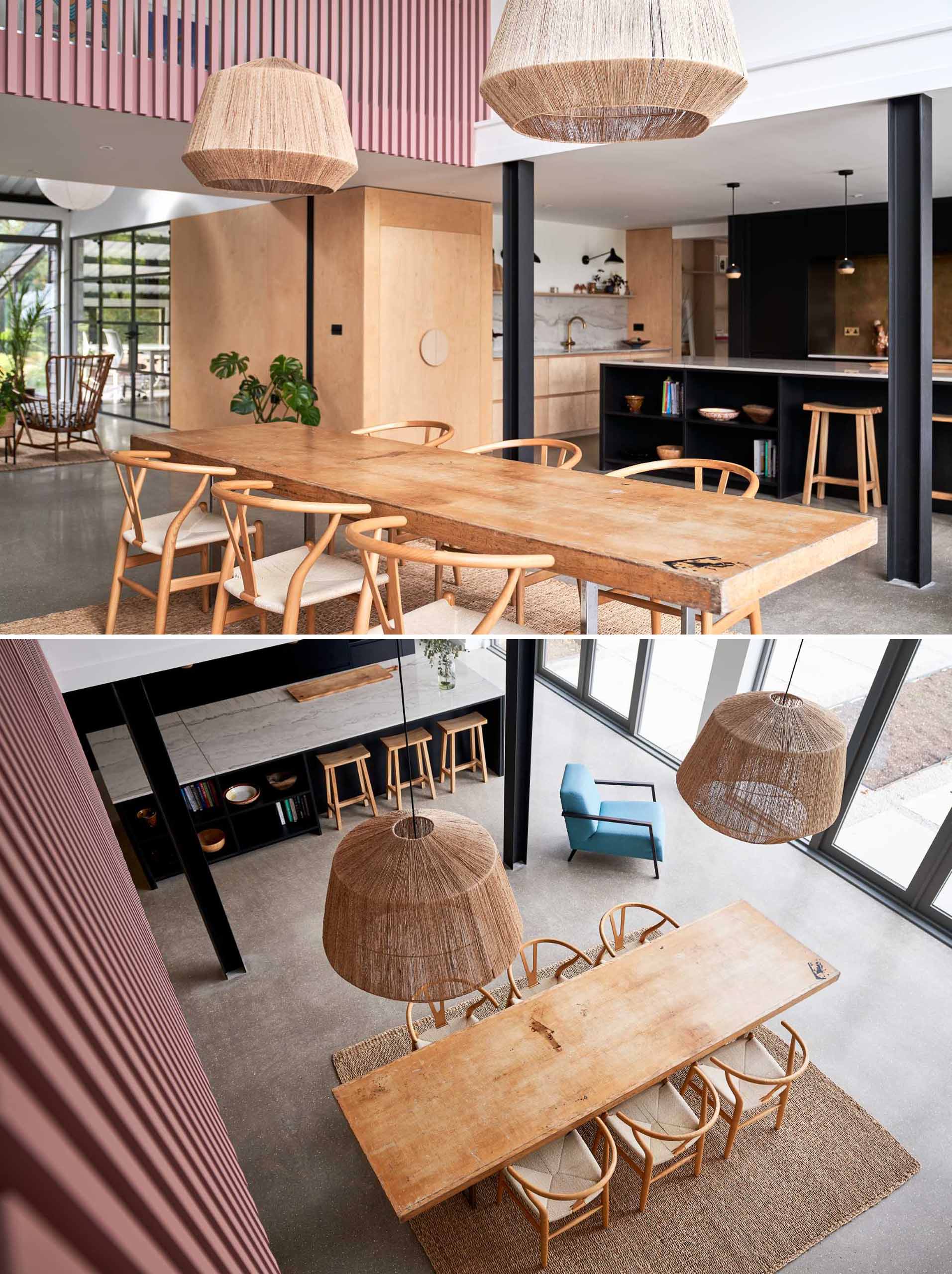 This modern open-plan dining area has a double-height ceiling, allowing the windows to flood the space with natural light, while doors open the interior to the patio and garden.