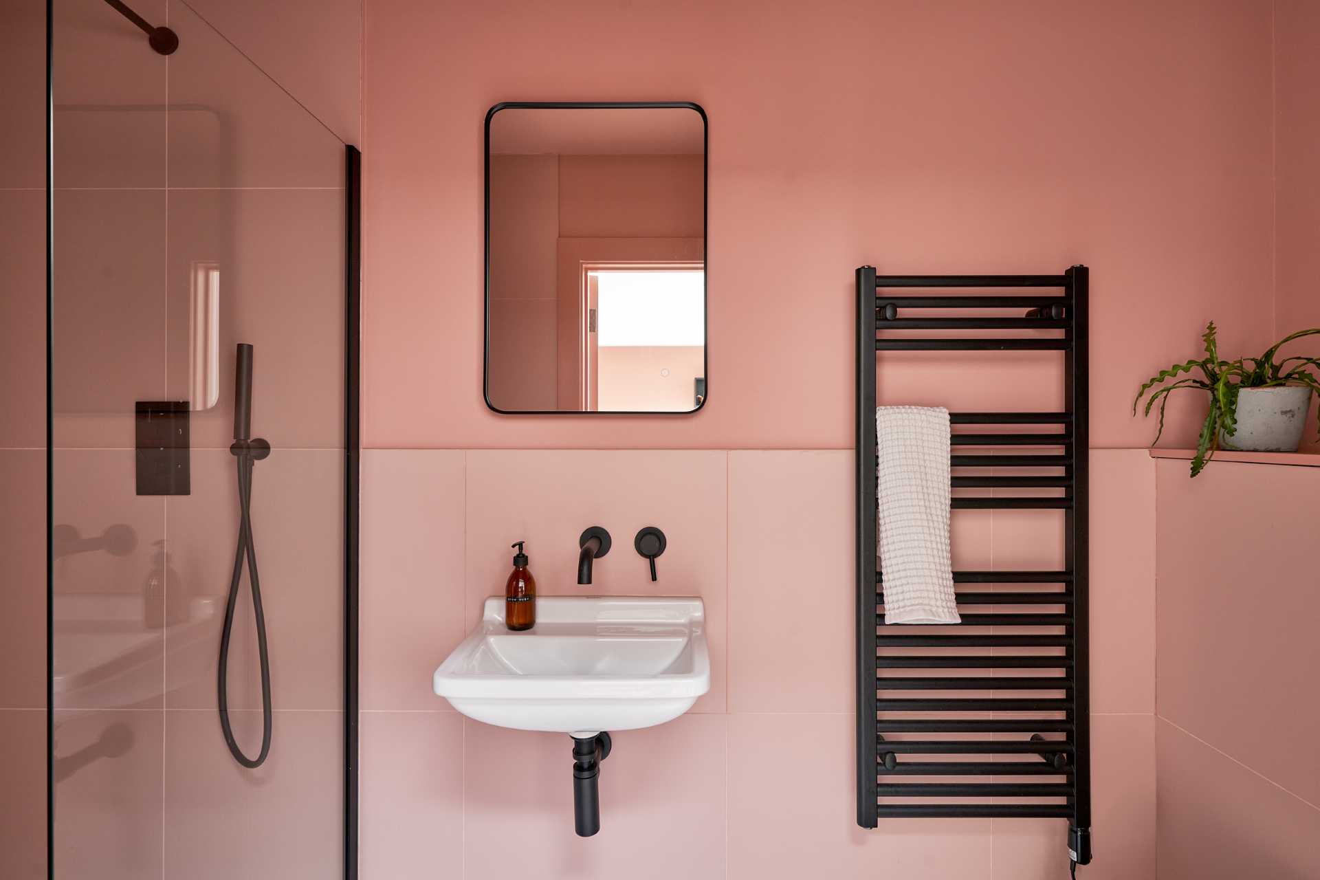 This modern bathroom has the walls and tiles in Suffolk Pink, a traditional color that's has been used in Suffolk county since the 14th century.