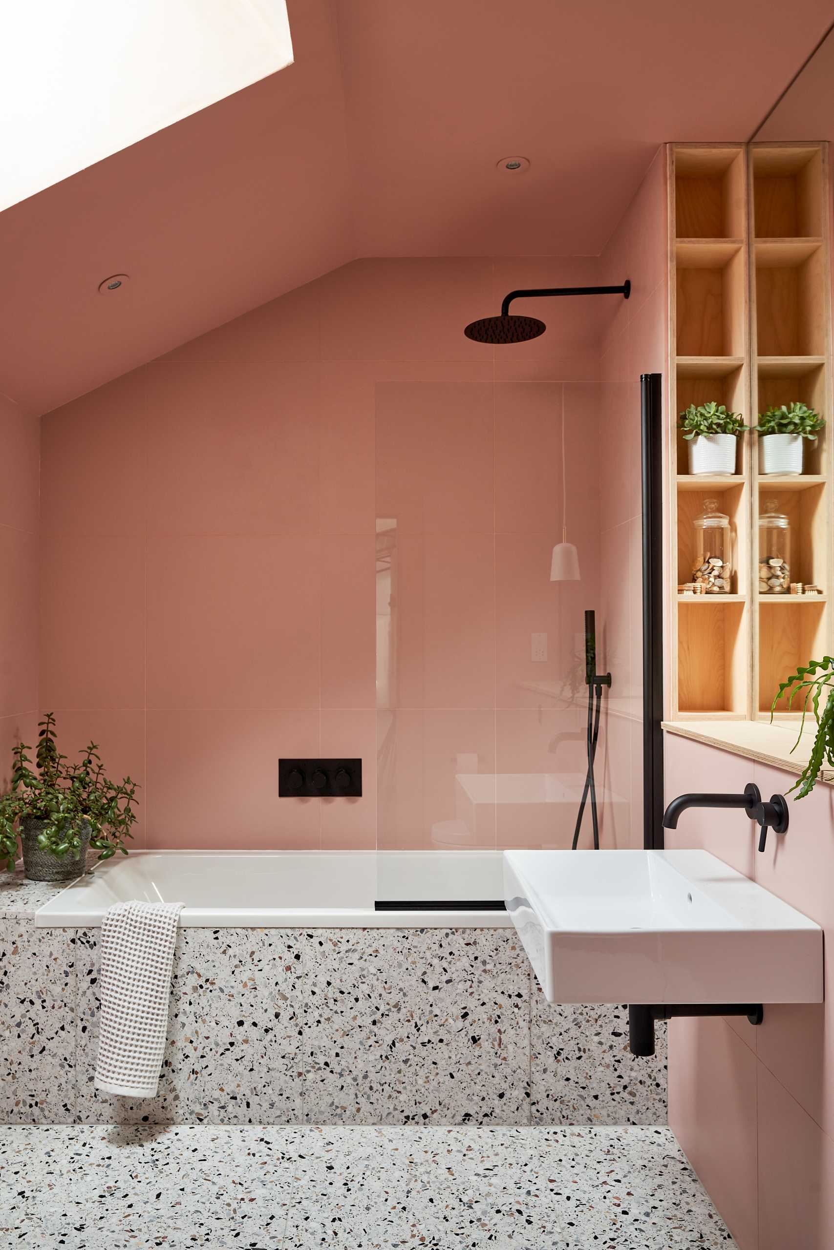 This modern bathroom has the walls and tiles in Suffolk Pink, a traditional color that's has been used in Suffolk county since the 14th century.