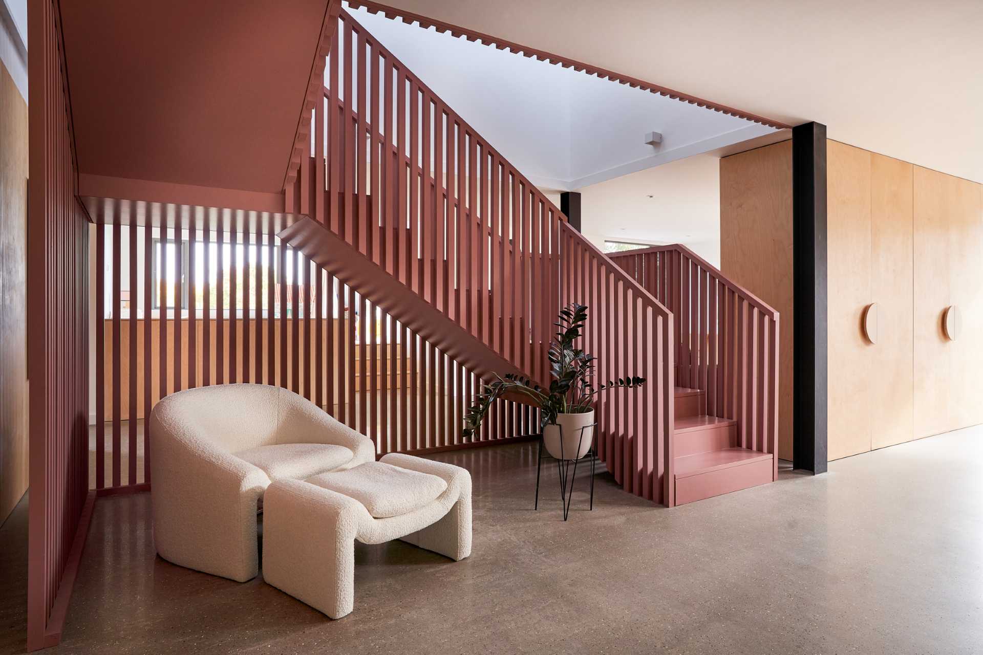 Suffolk Pink inspired stairs add an eye-catching colorful design element to the interior.