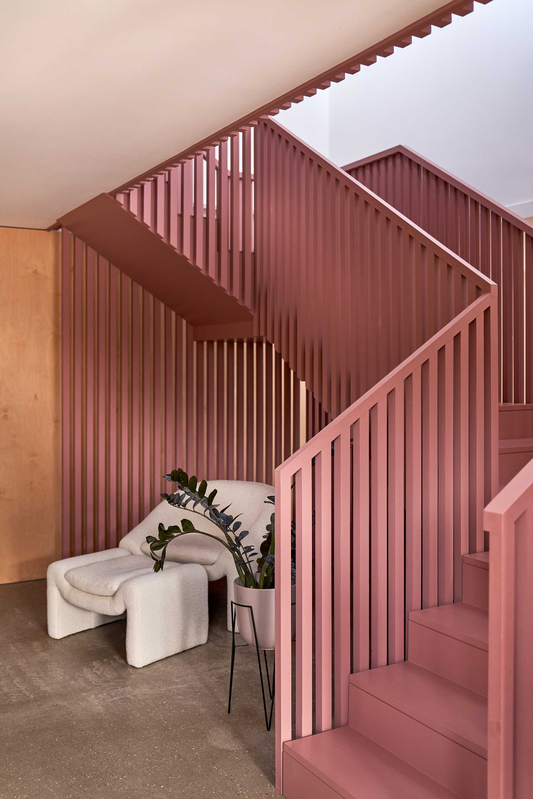 Suffolk Pink inspired stairs add an eye-catching colorful design element to the interior.