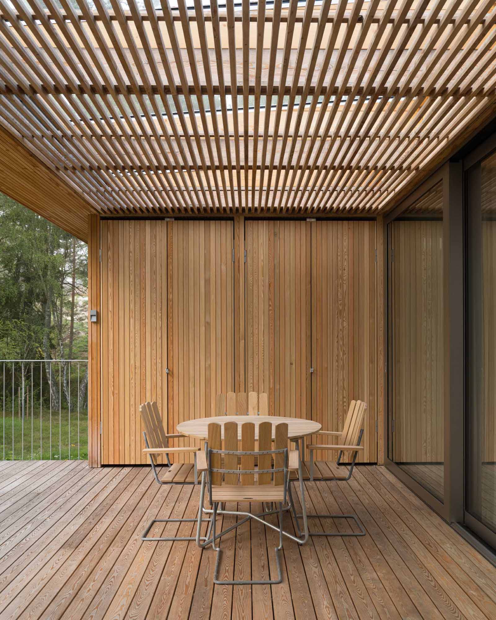 This covered deck, designed for outdoor dining, also has built-in storage.