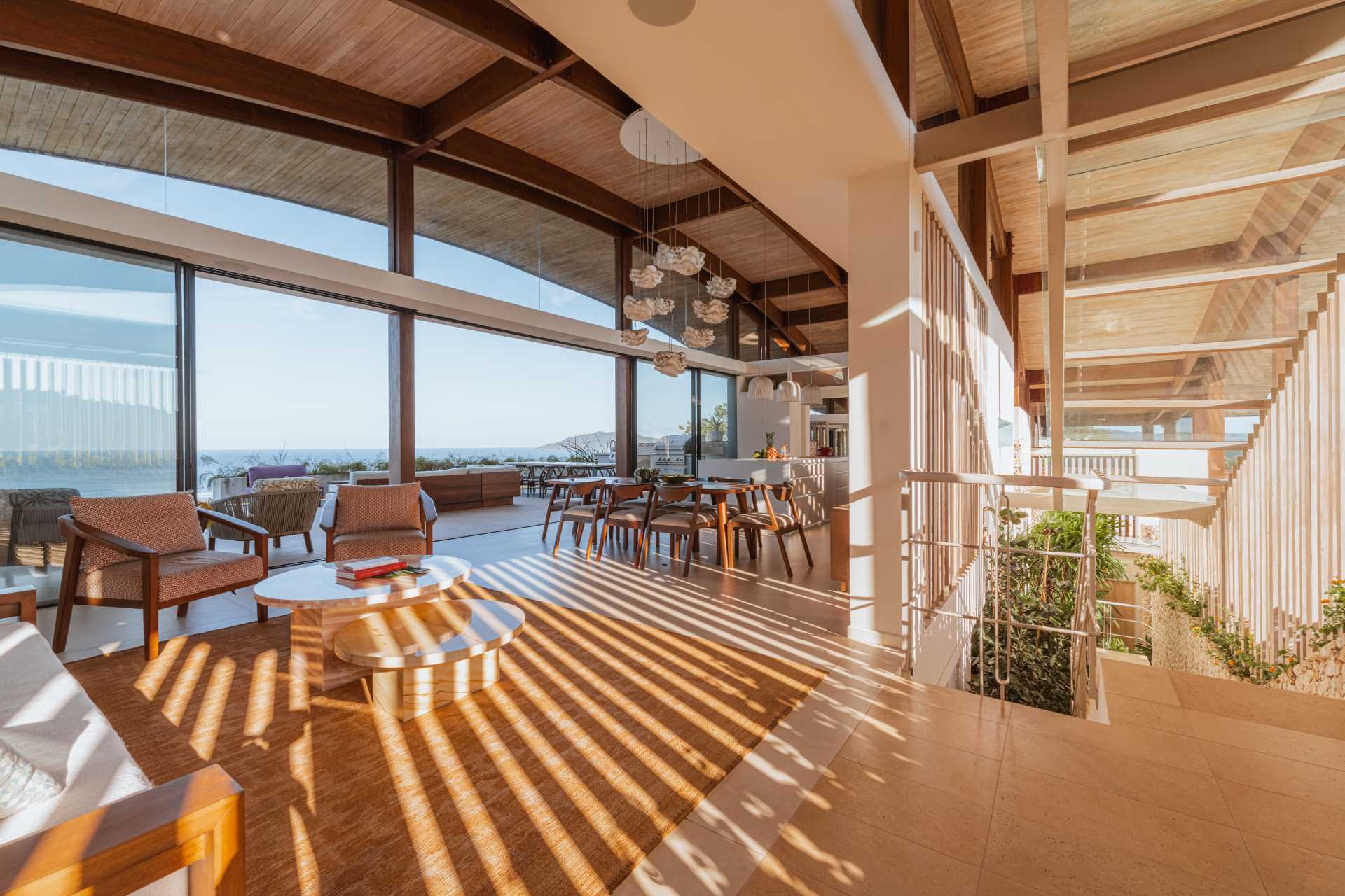 A modern interior with an open plan living room, dining area, and kitchen.