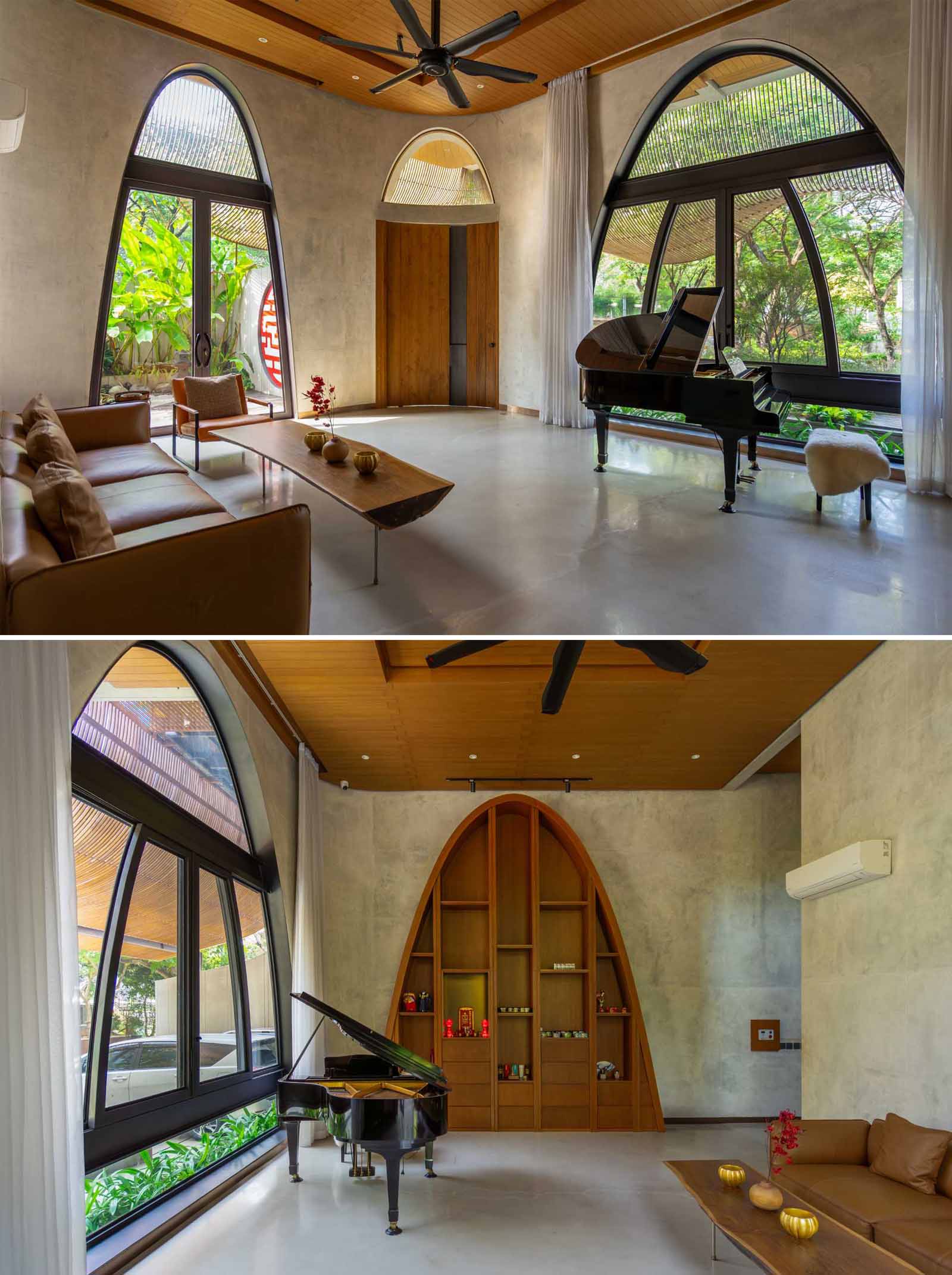 A modern foyer with a sitting area and piano, features arched windows and bookshelf.