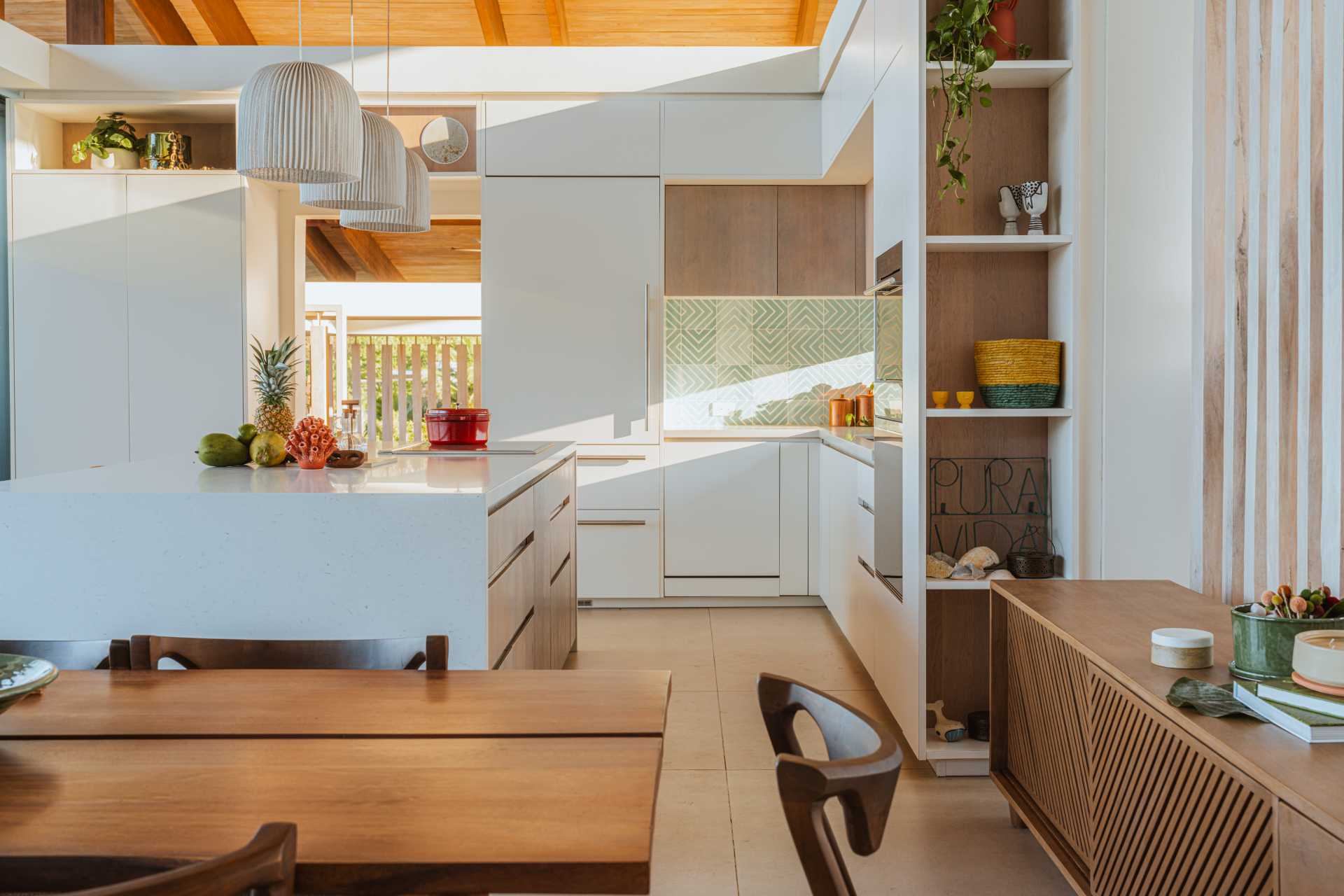 A modern white kitchen in an open plan interior.