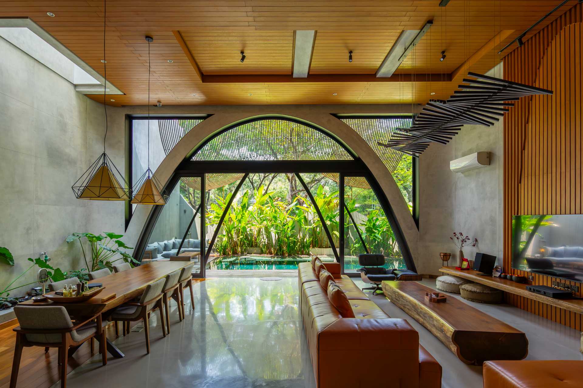 A modern home with an arched opening in the combined living room and dining area.