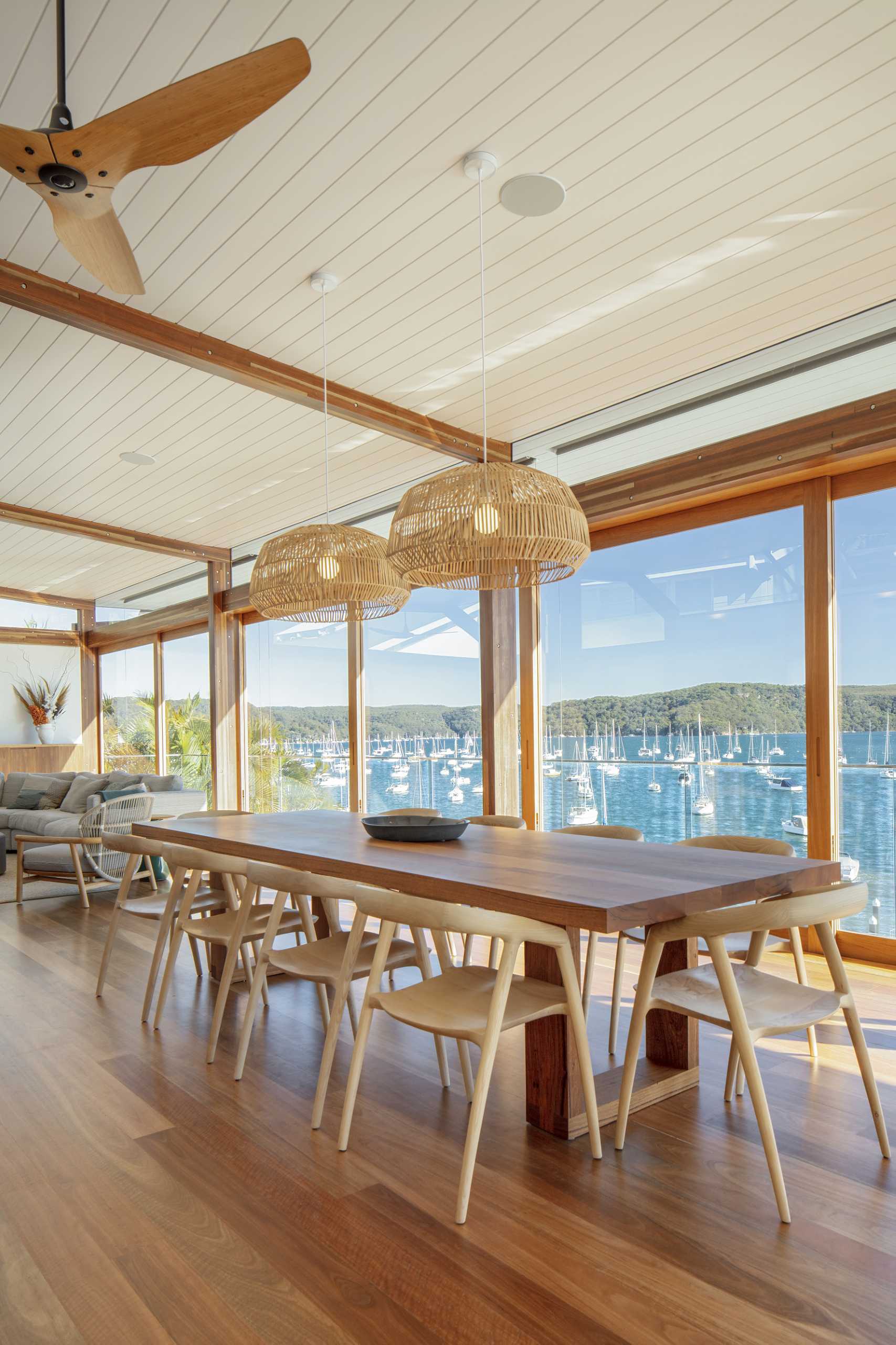 The open-plan dining area runs alongside the sliding wood-framed doors.