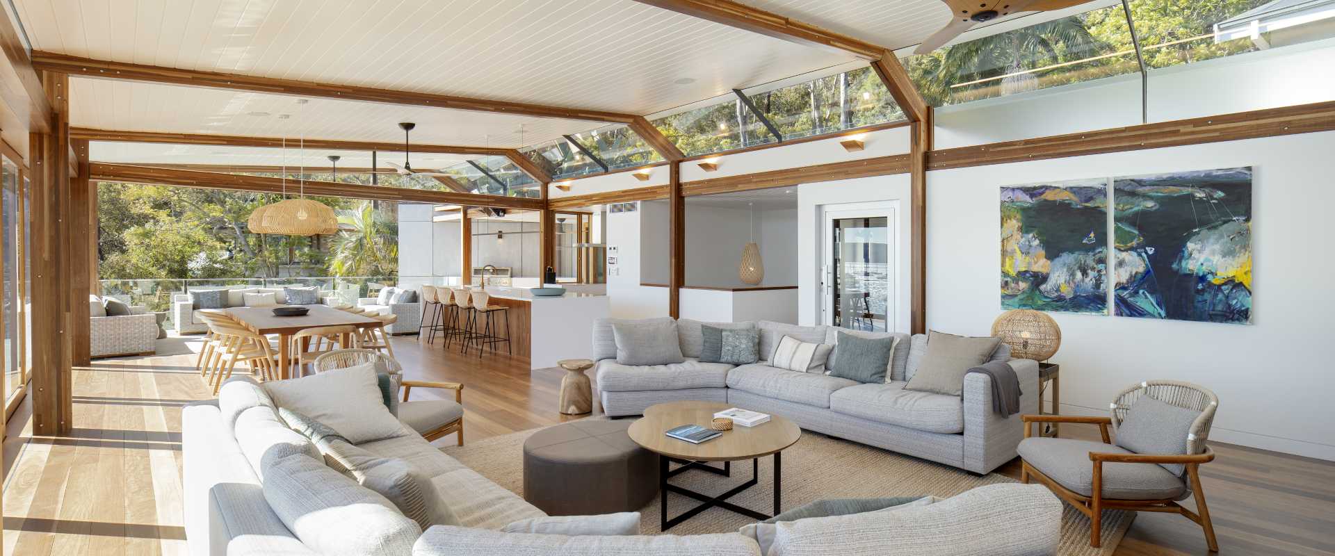 Inside this modern home, the open plan living, dining, and kitchen area are connected via the Spotted Gum flooring, while an abundance of windows fills the space with natural light.