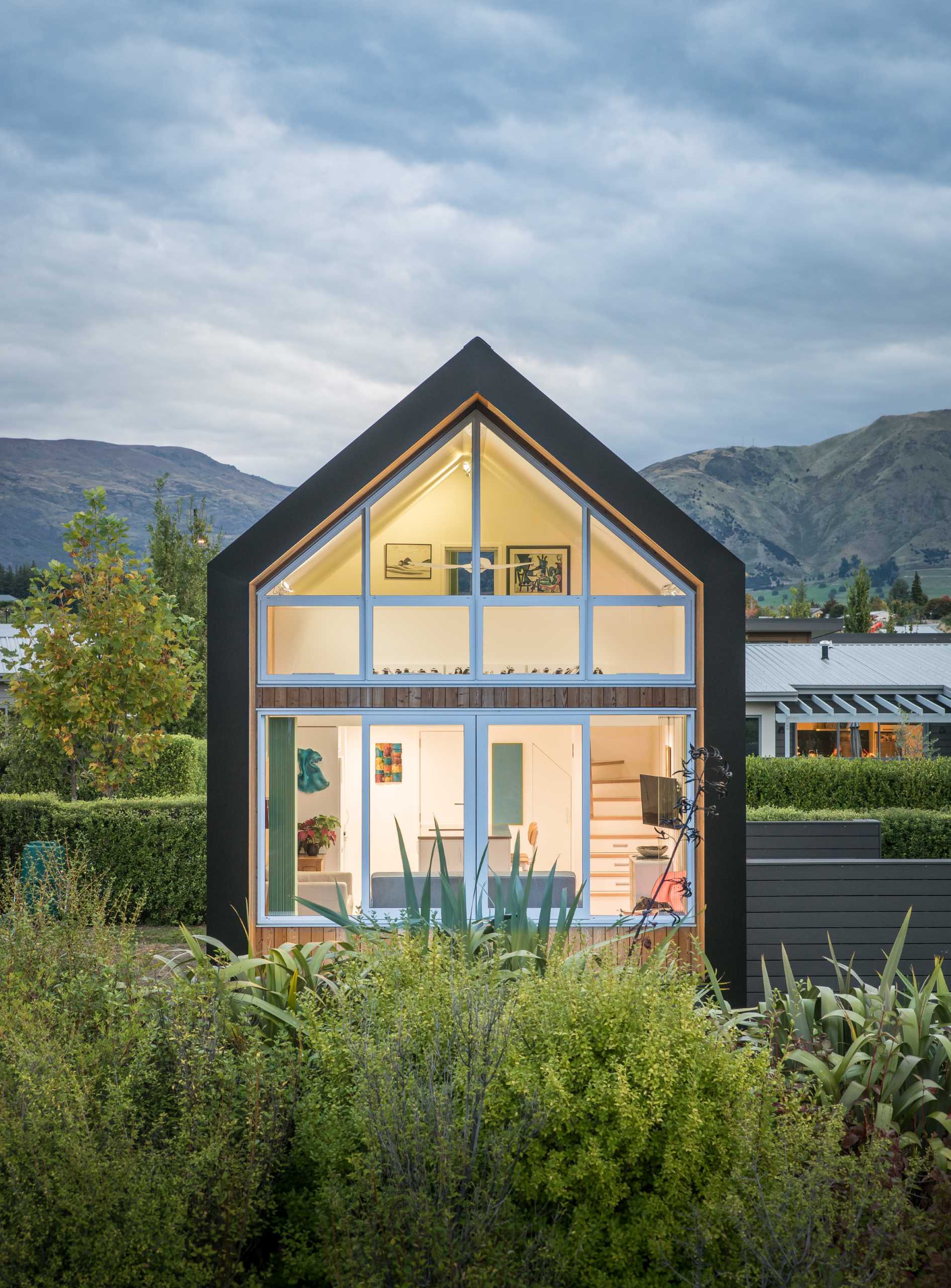 A small one bedroom home with an exterior of asphalt shingles and larch weatherboards.